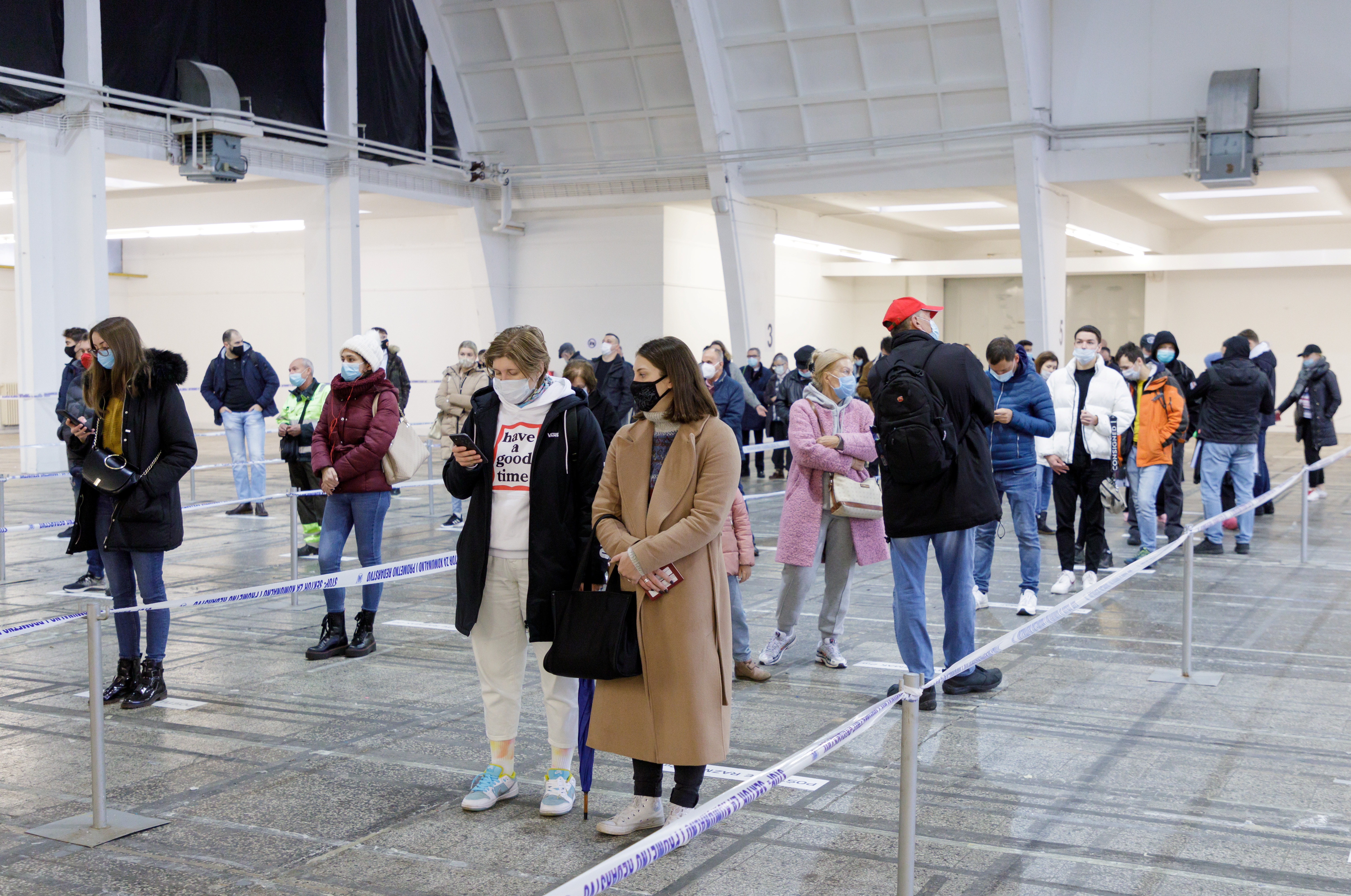 People from Russia wait to receive a dose of the COVID-19 vaccine at a vaccination center in Zagreb