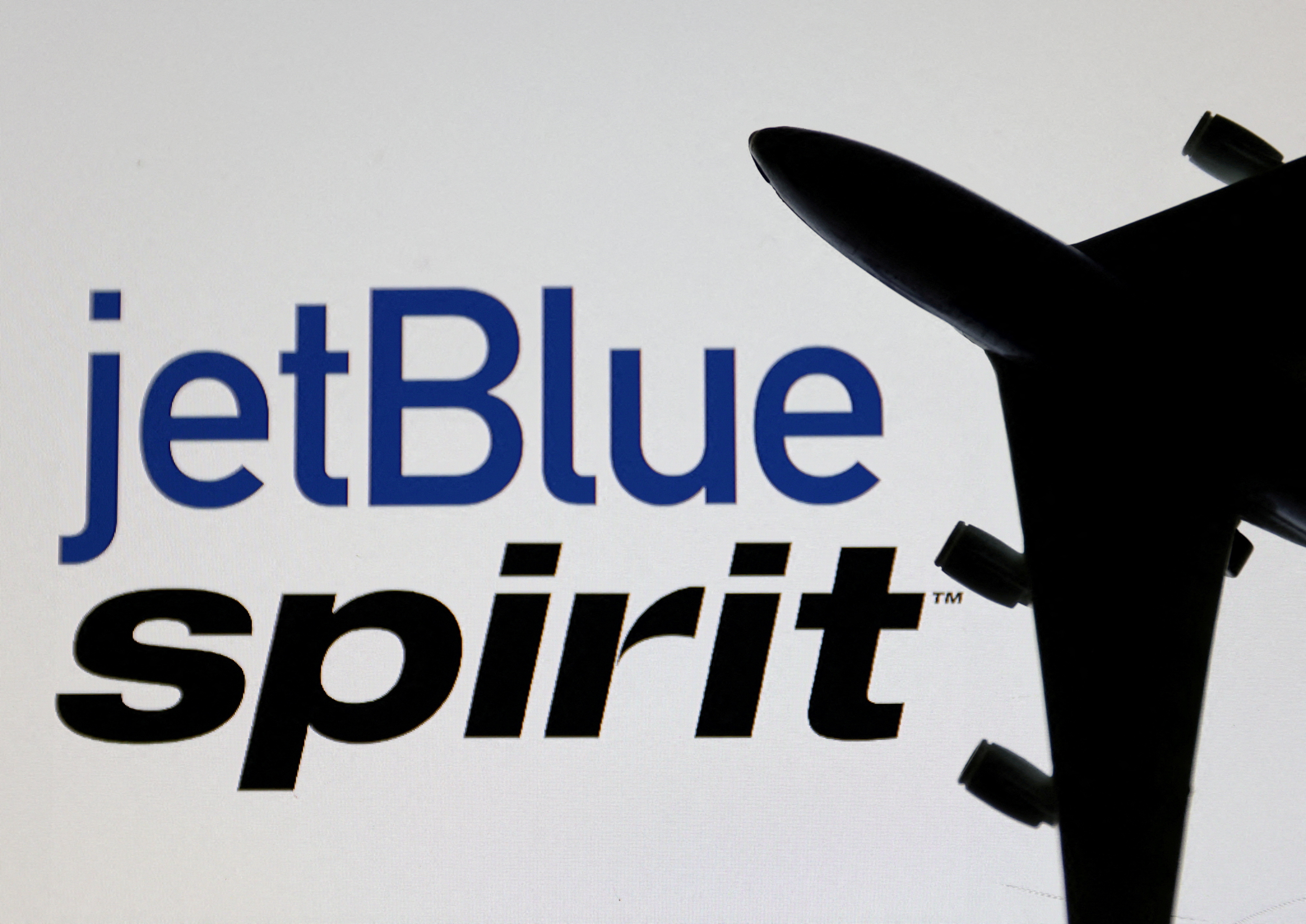 Illustration shows Spirit Airlines and jetBlue Airways logos