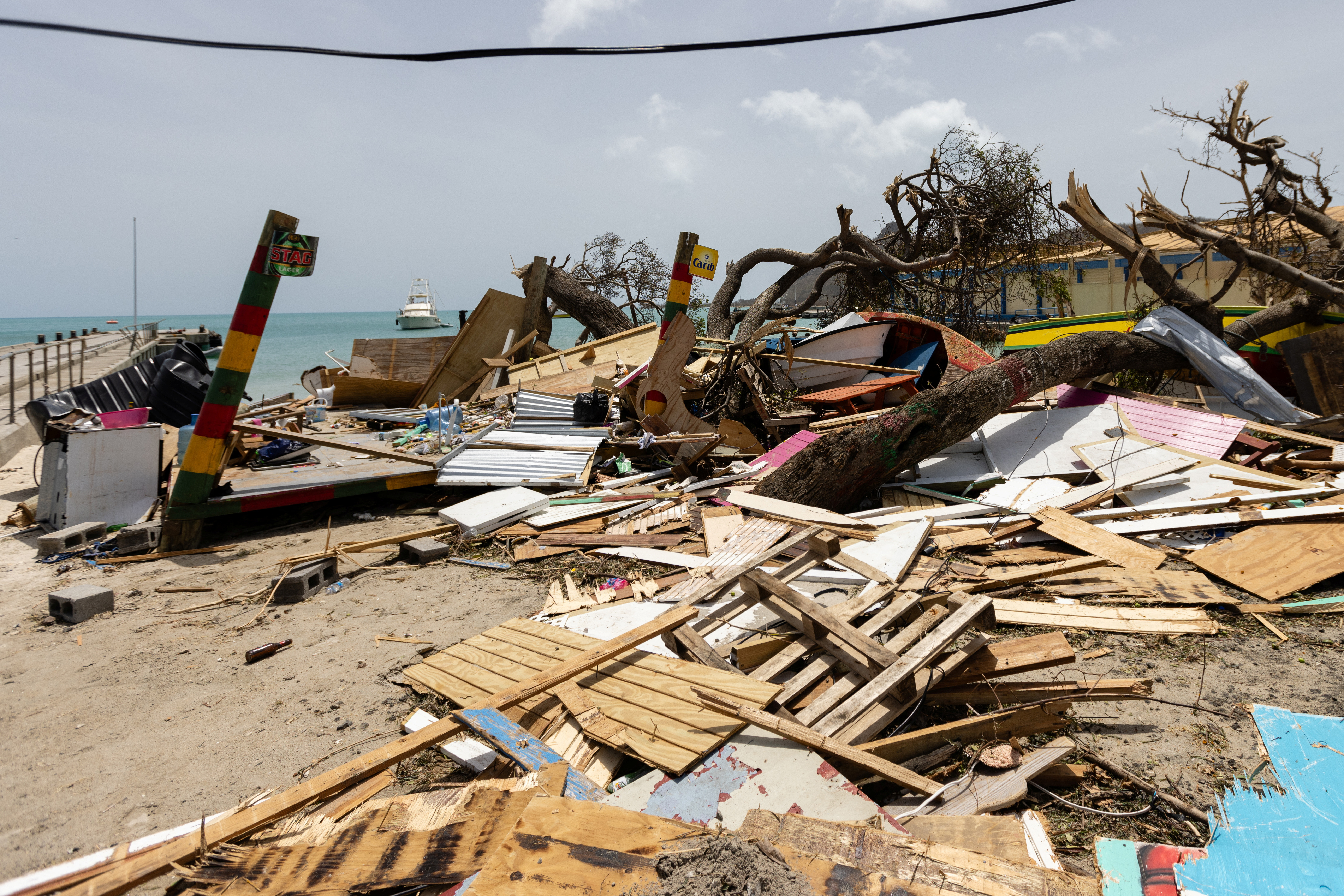 Scattered debris clutters the waterfront after Hurricane Beryl passed the island of Carriacou