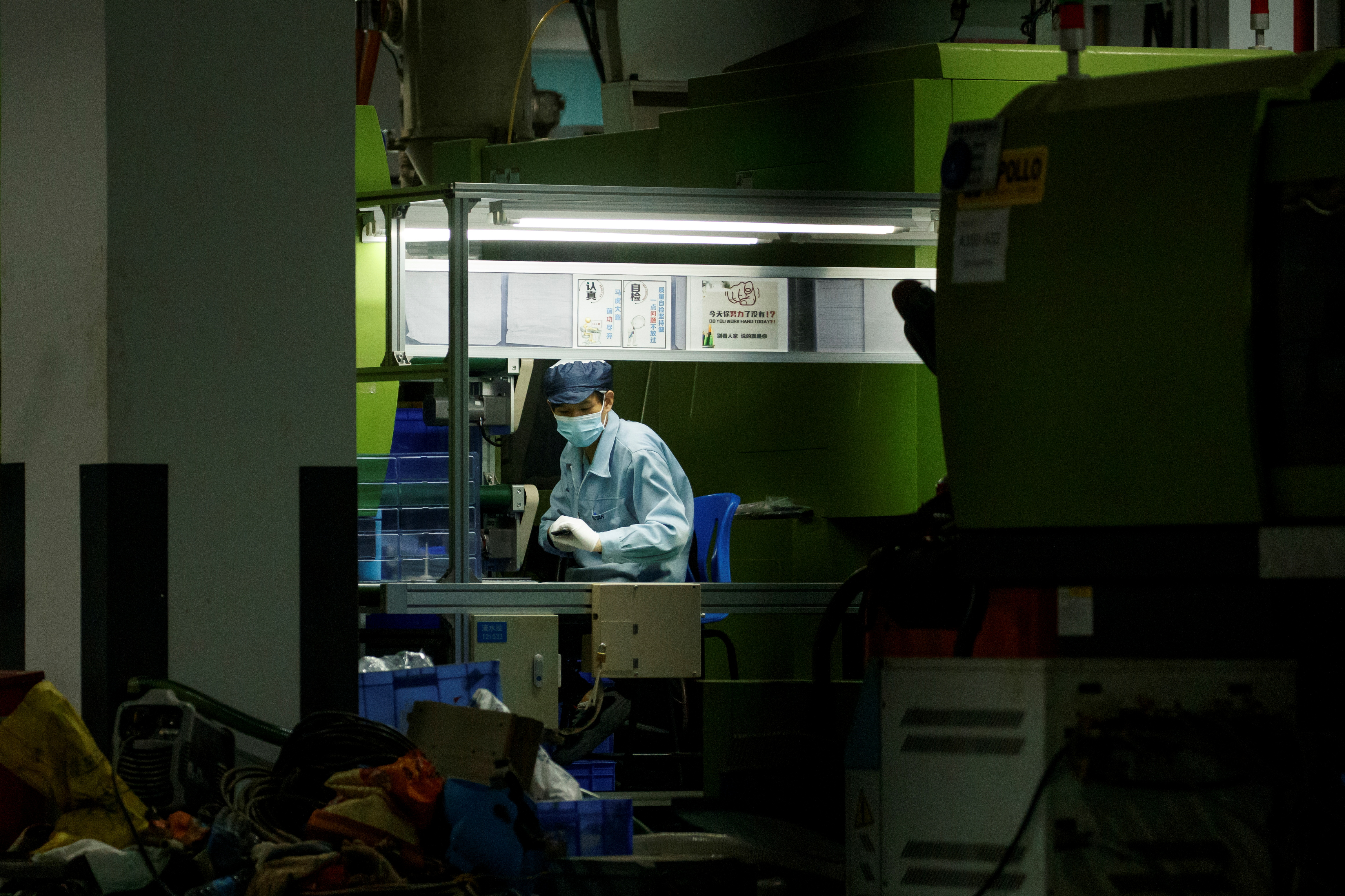 Man works at a manufacturing plant of Universal Electronics Inc in Qinzhou