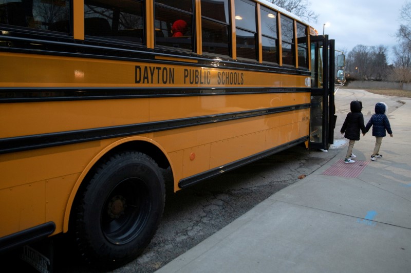 A bus drops students off as classes resume after teachers received the coronavirus disease (COVID-19) vaccination, at Westwood Elementary School in Dayton, Ohio, U.S., March 1, 2021. REUTERS/Megan Jelinger/File Photo