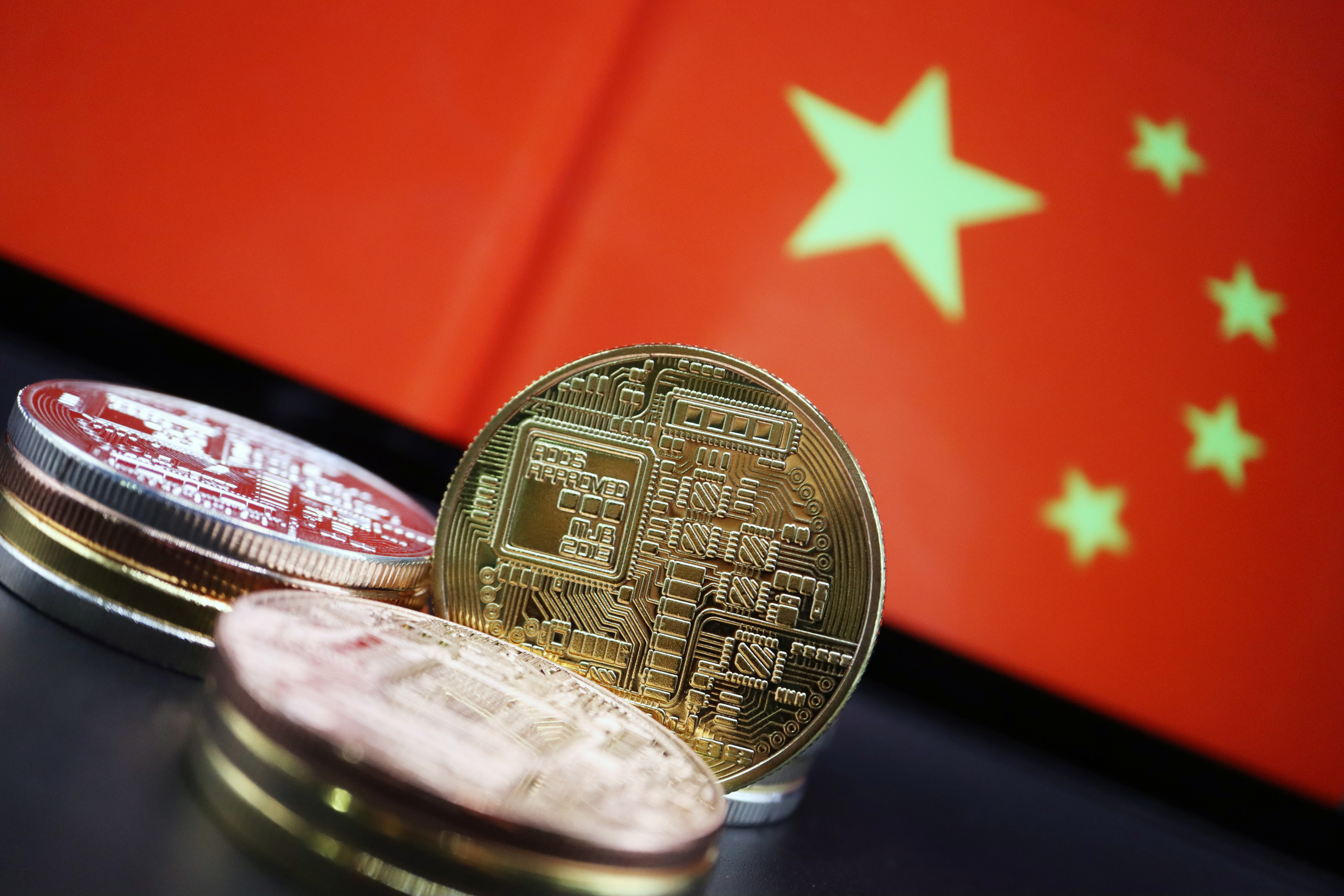 Cryptocurrency representations are seen in front of an image of the Chinese flag in this illustration picture taken June 2, 2021. REUTERS/Florence Lo/Illustration