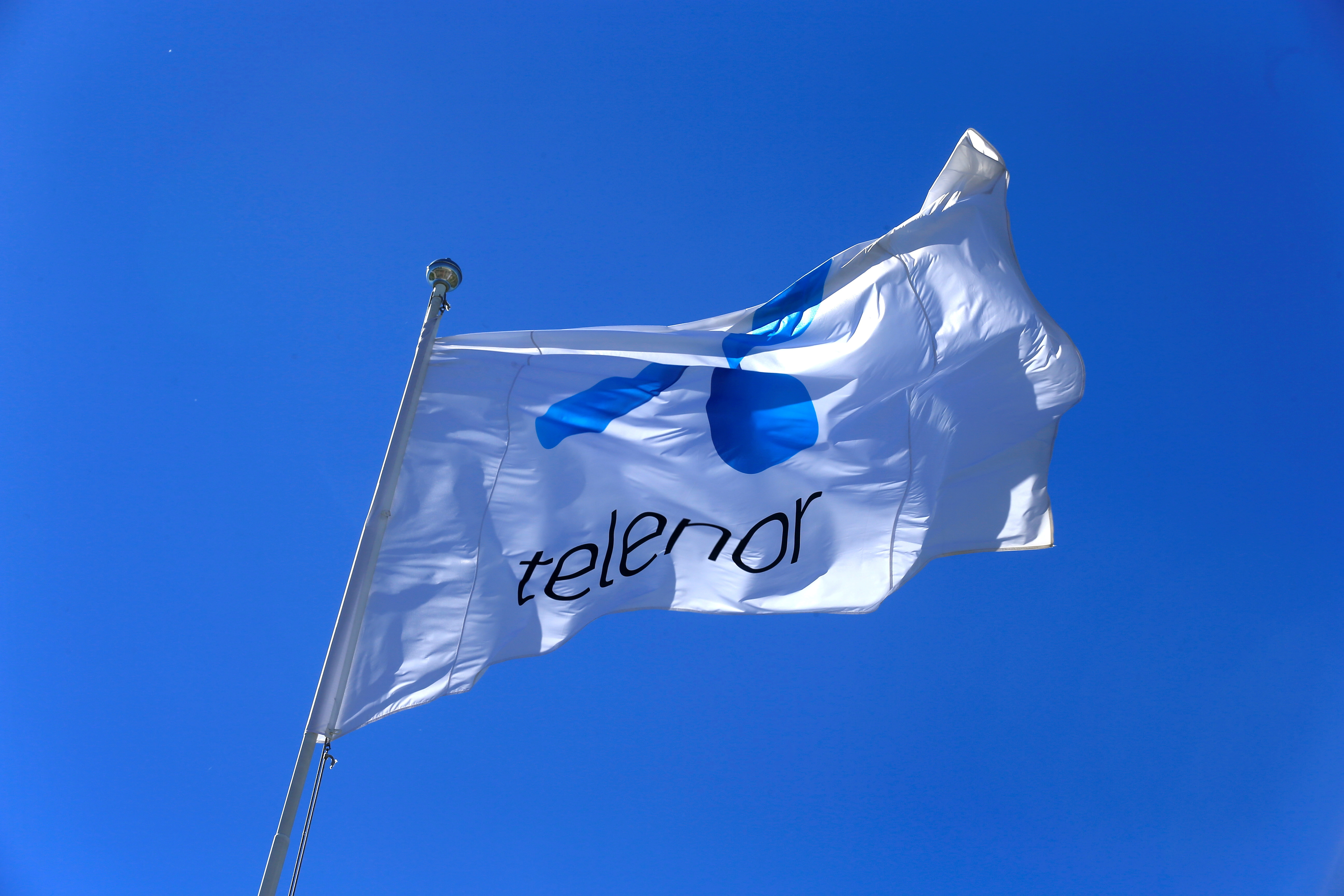 Telenor flag flutters next to the company's headquarters in Fornebu