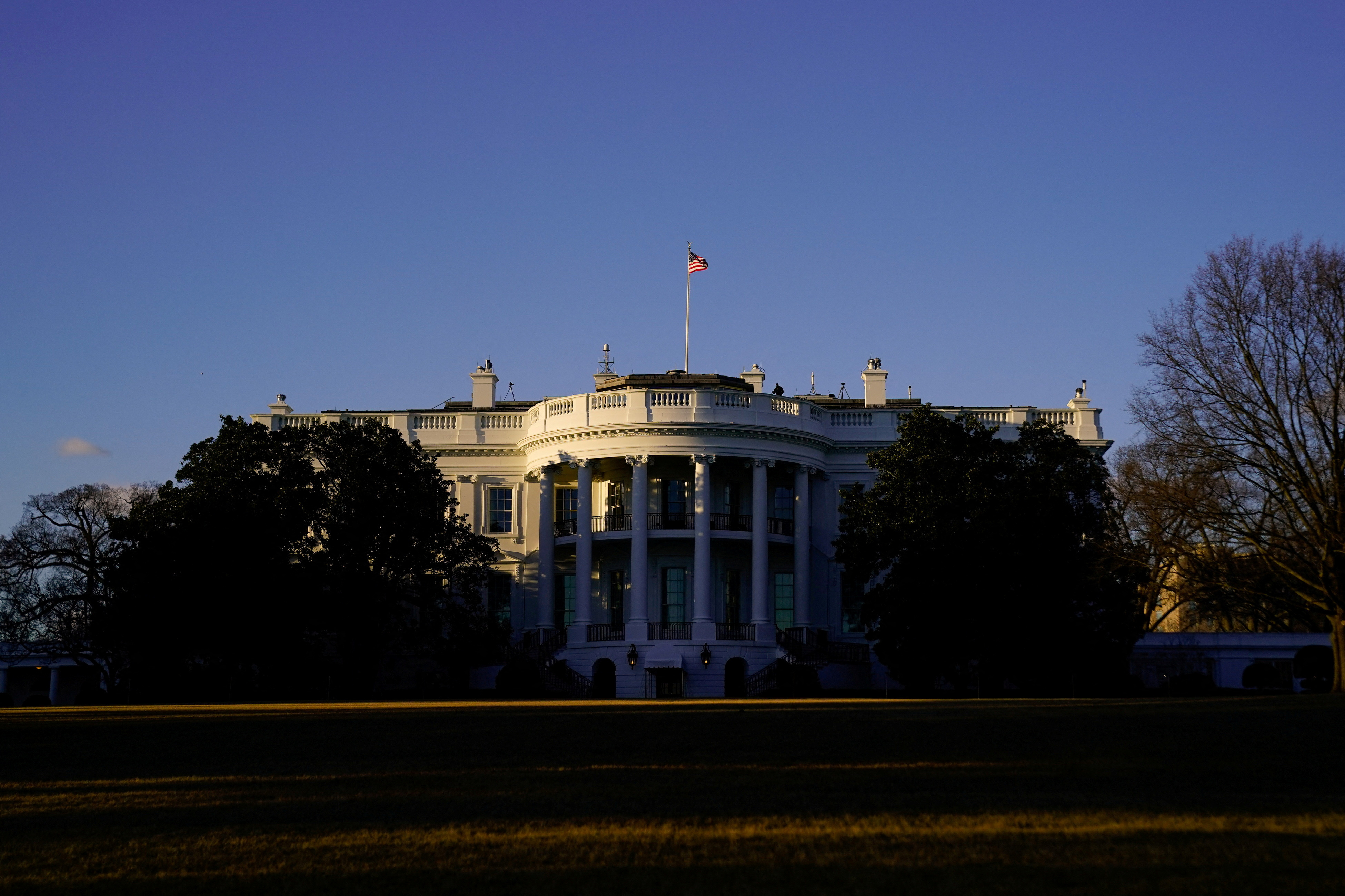 The White House is seen at sunset in Washington