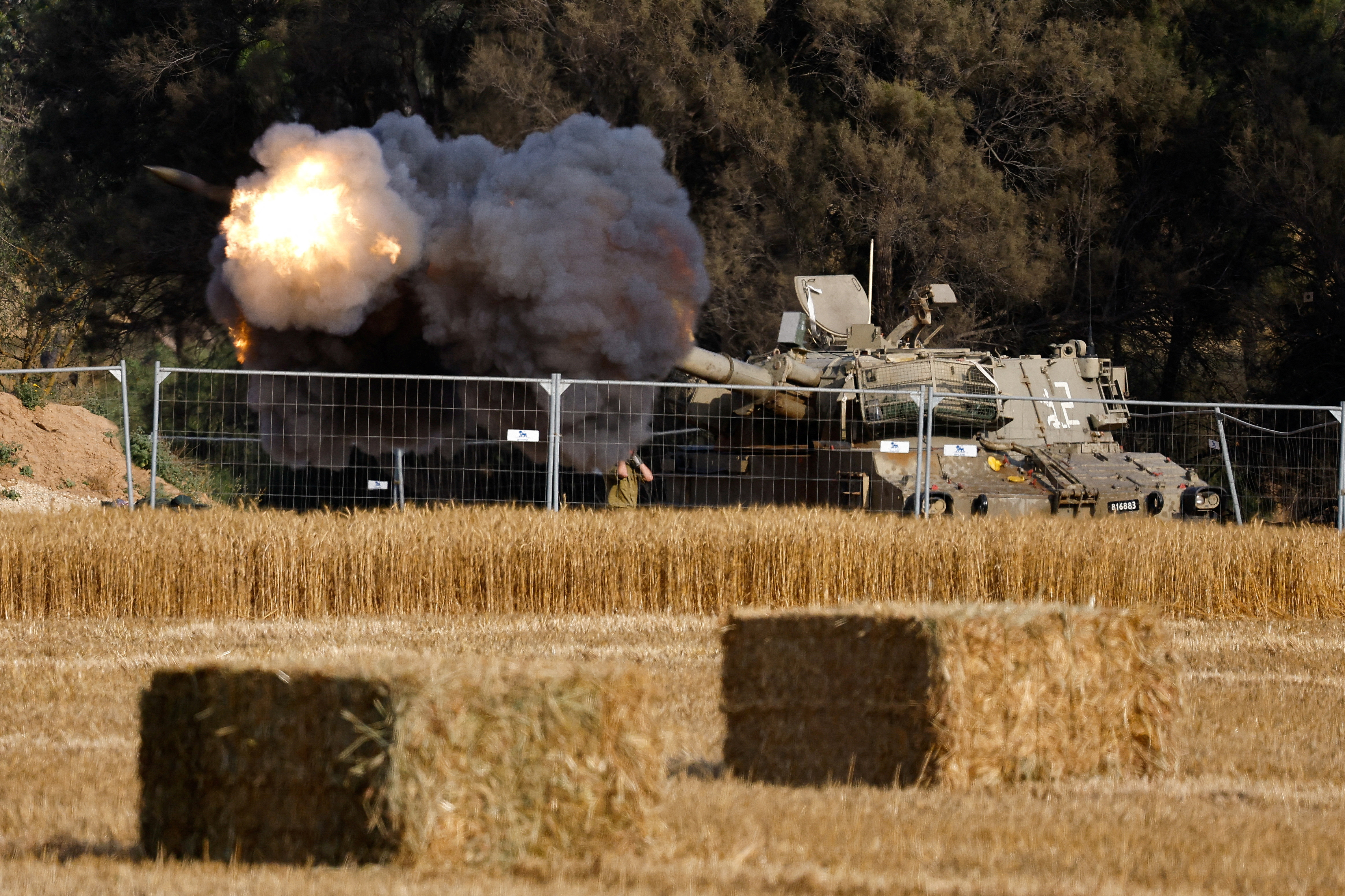 An Israeli mobile artillery unit fires towards Gaza, near the Israel-Gaza border