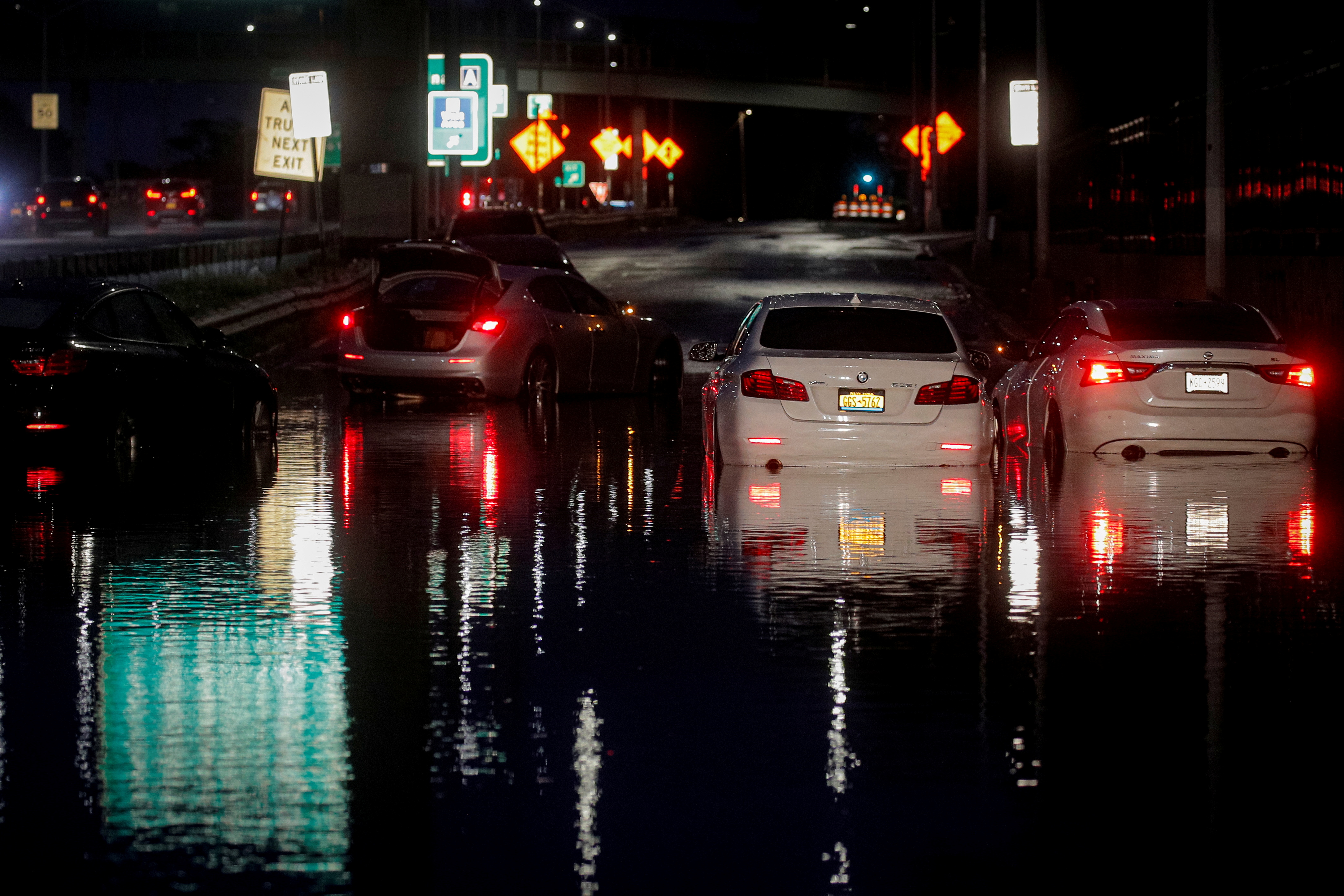 Abandoned cars are left on a flooded highway in Queens, New York