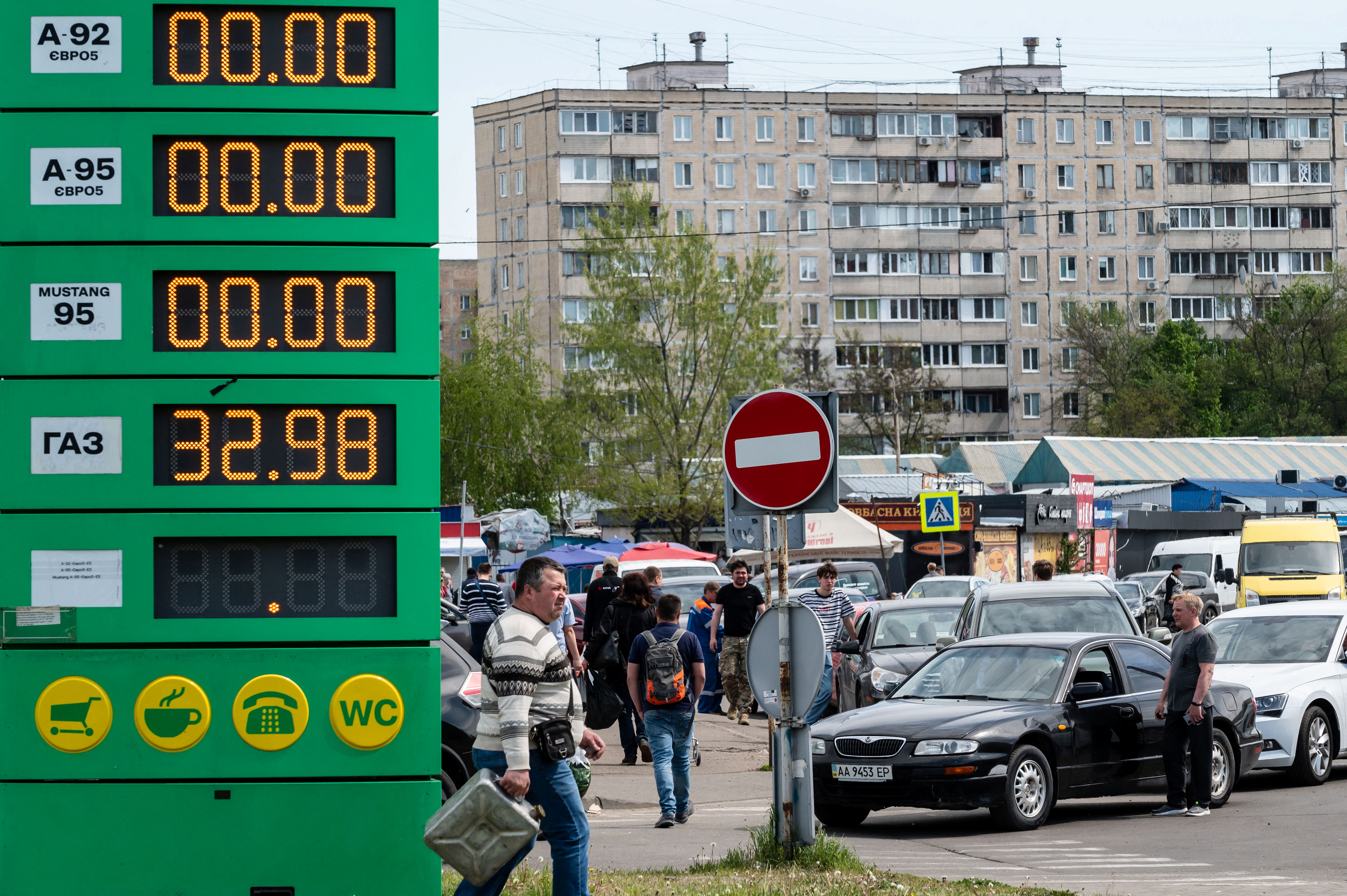 Drivers stay in line outside a petrol station as they try to buy fuel in Kyiv