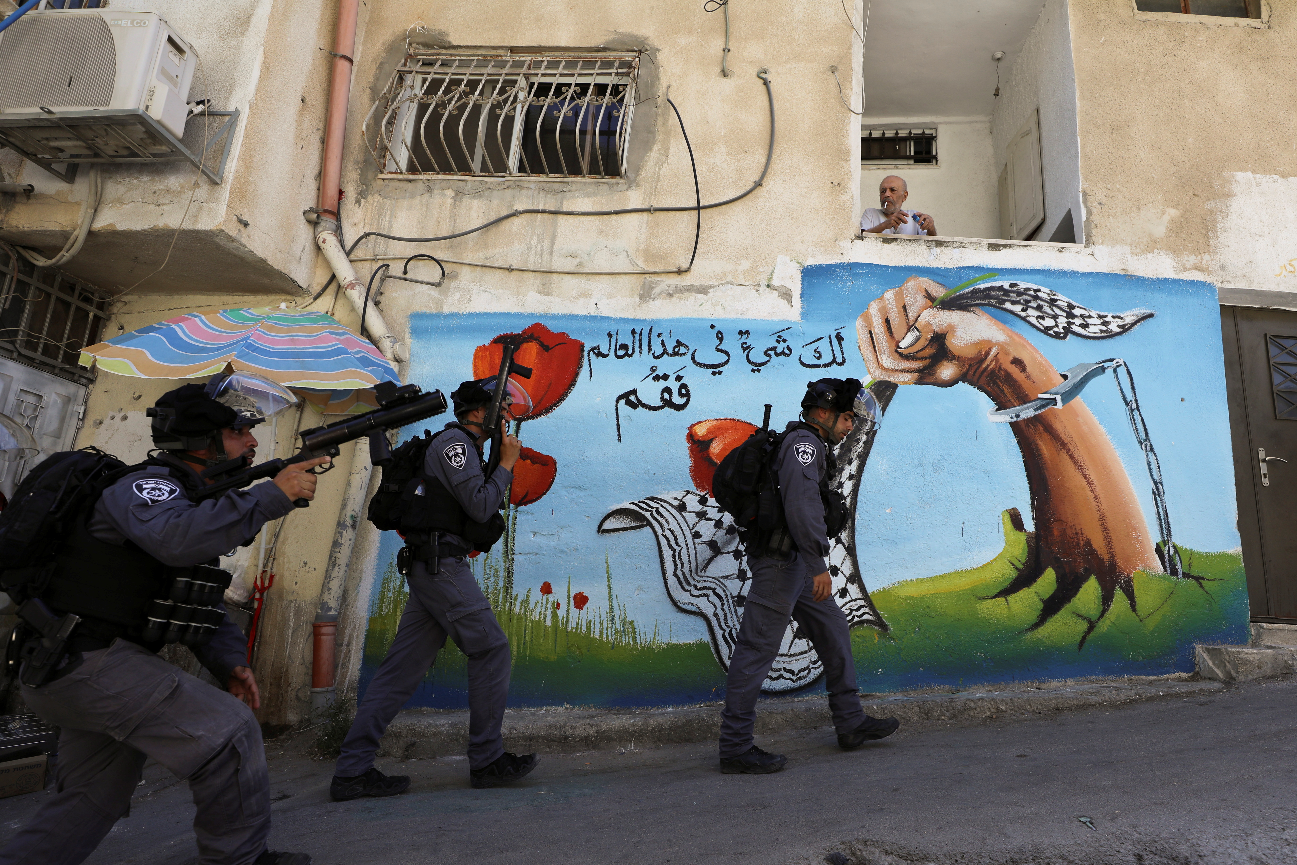 Israeli security force members walk past a house during clashes with Palestinians which erupted over Israel's demolition of a shop in the Palestinian neighbourhood of Silwan in East Jerusalem