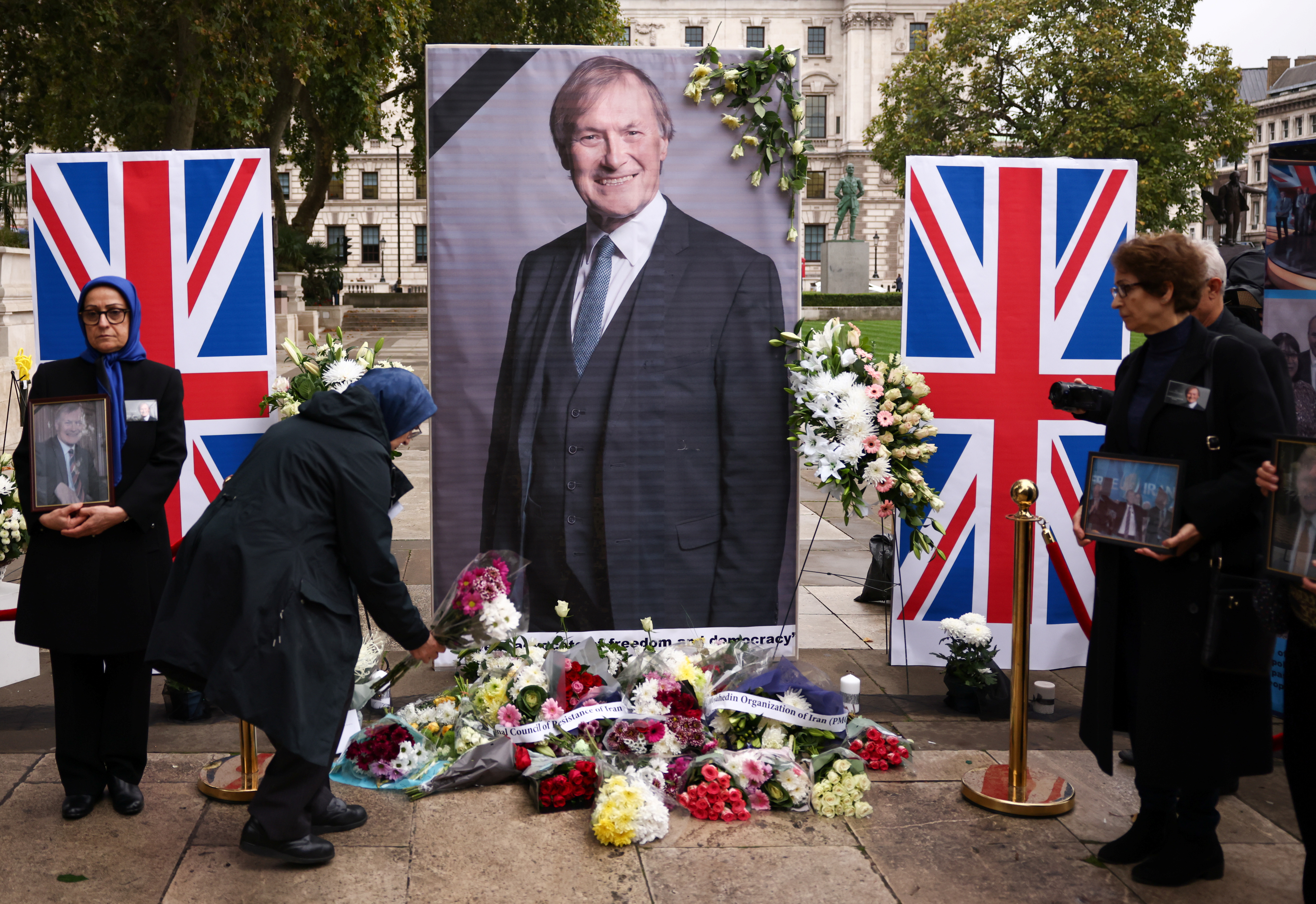 People pay tribute to late British MP David Amess, in London