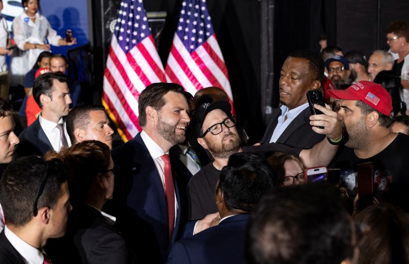 Republican vice presidential nominee Senator JD Vance poses for a selfie with a supporter after a press conference in Philadelphia