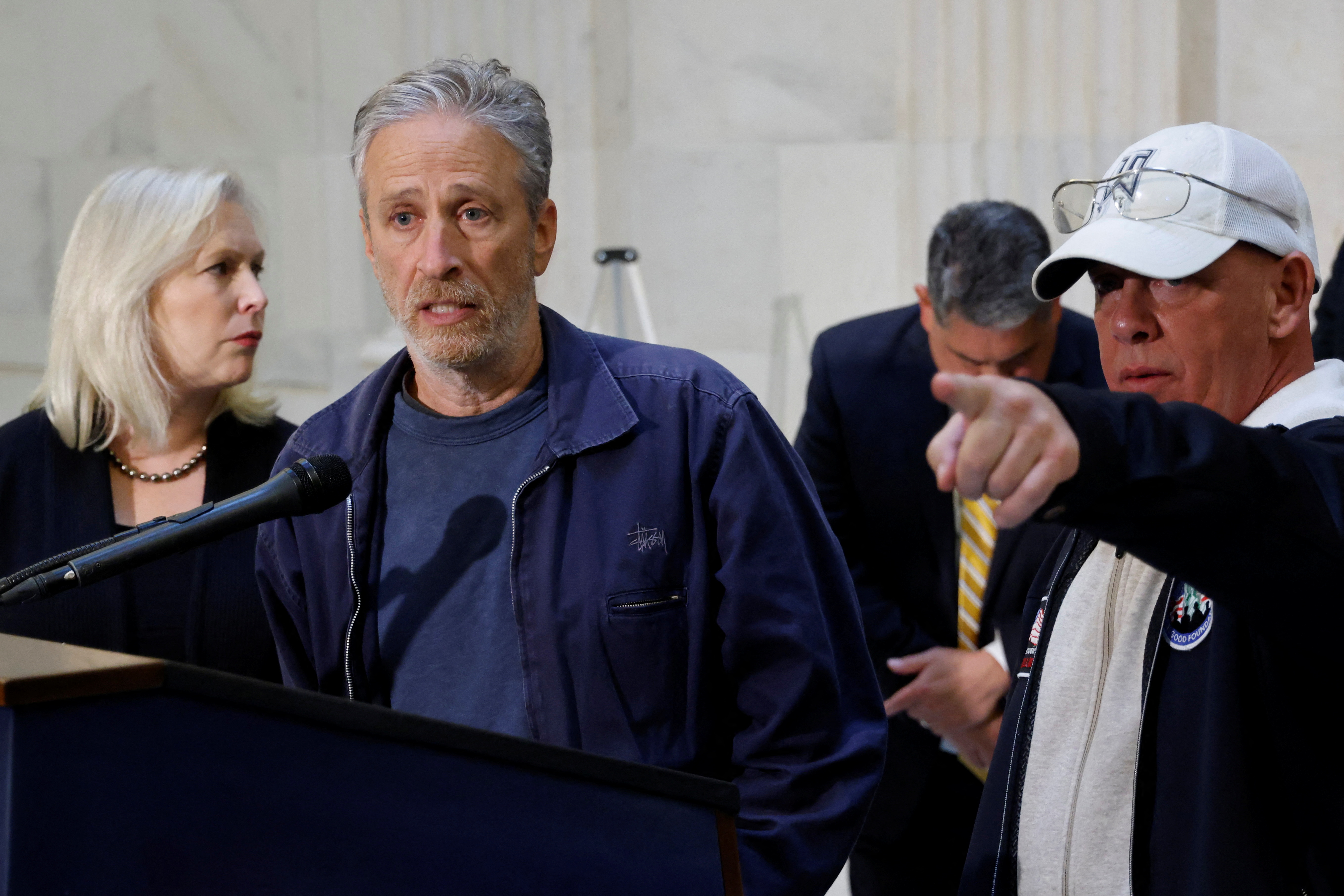Jon Stewart, with U.S. Sen. Gillibrand and activist Feal, speaks to reporters about their effort to raise awareness for U.S. veterans suffering from military toxic exposures, on Capitol Hill in Washington