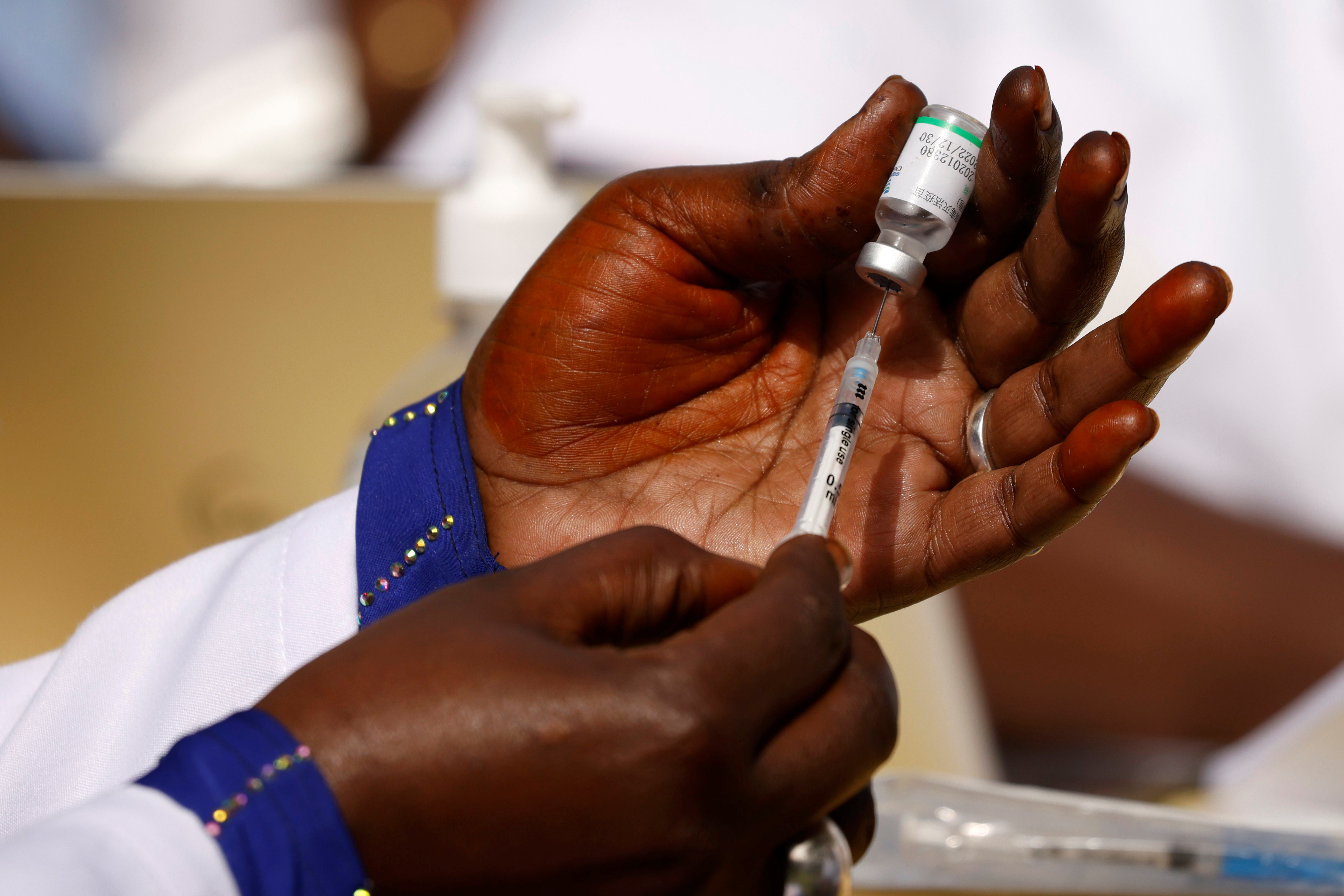 A health worker preapres a dose of the coronavirus disease (COVID-19) vaccine in Dakar, Senegal February 23, 2021. REUTERS/ Zohra Bensemra