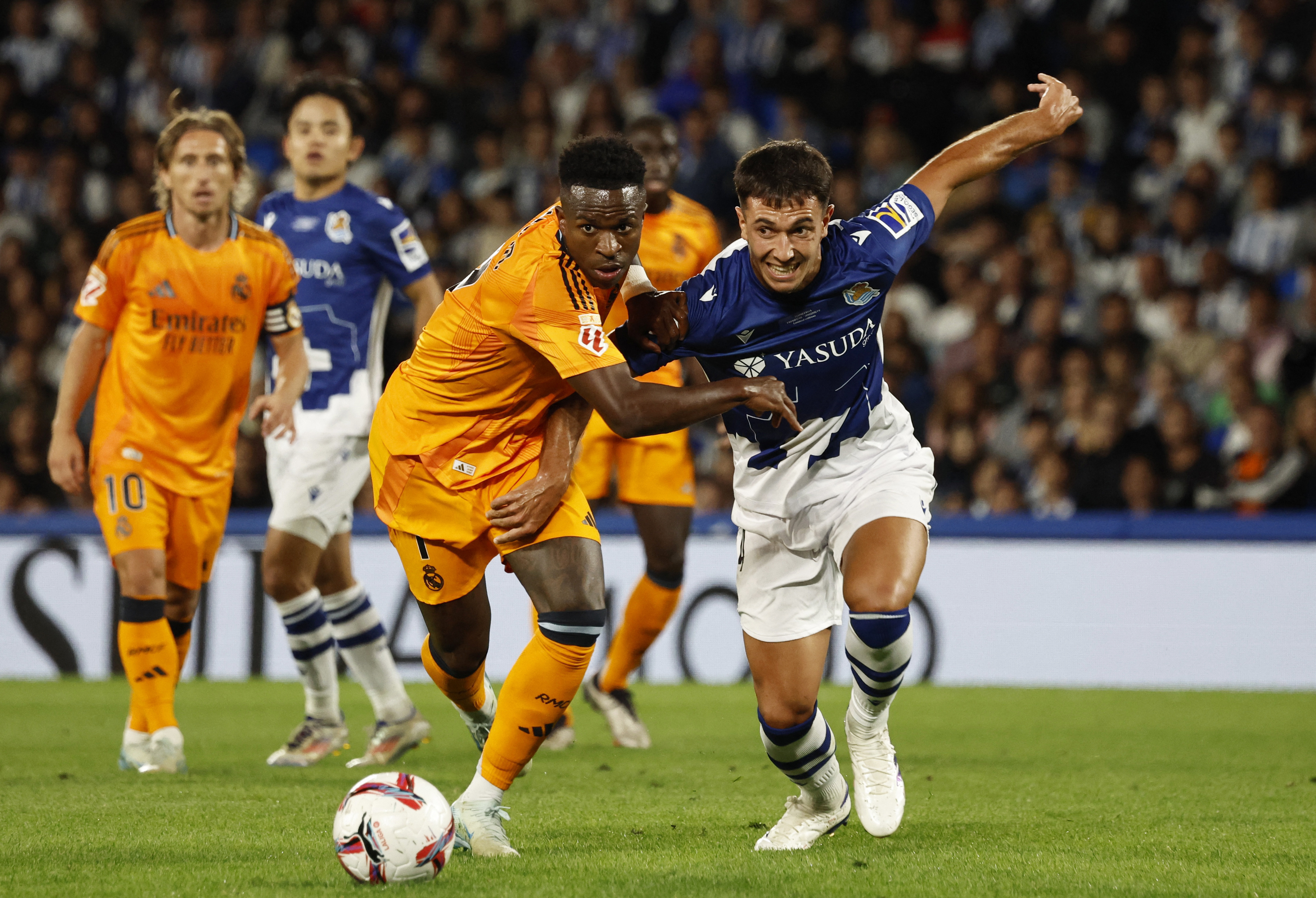 Soccer Football - LaLiga - Real Sociedad v Real Madrid - Reale Arena, San Sebastian, Spain - September 14, 2024 Real Madrid's Vinicius Junior in action with Real Sociedad's Martin Zubimendi REUTERS/Vincent West