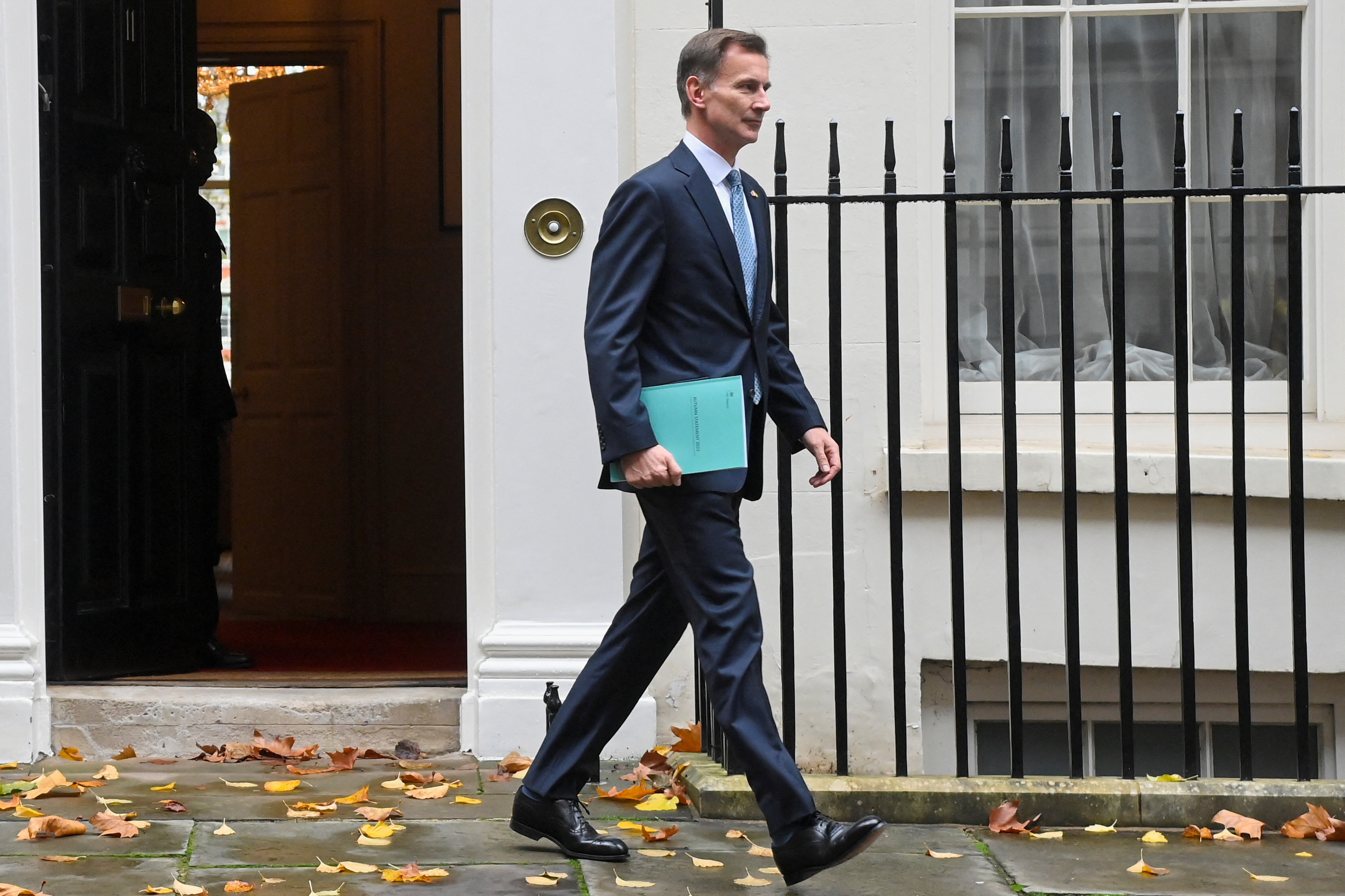 Britain's Chancellor of the Exchequer Jeremy Hunt walks down Downing Street in London