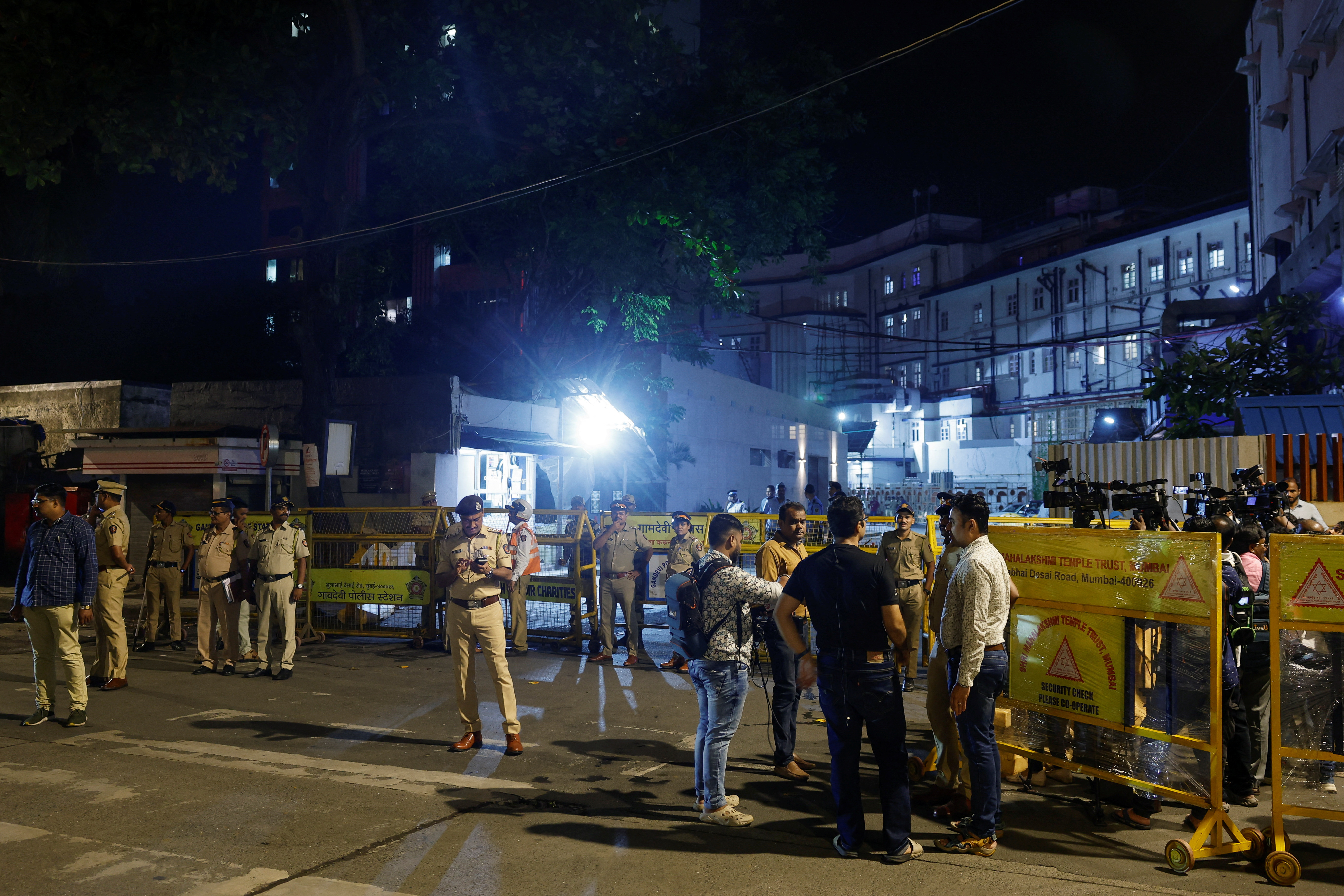 Media wait outside a hospital where former chairman of Tata Group, Ratan Tata passed away in Mumbai