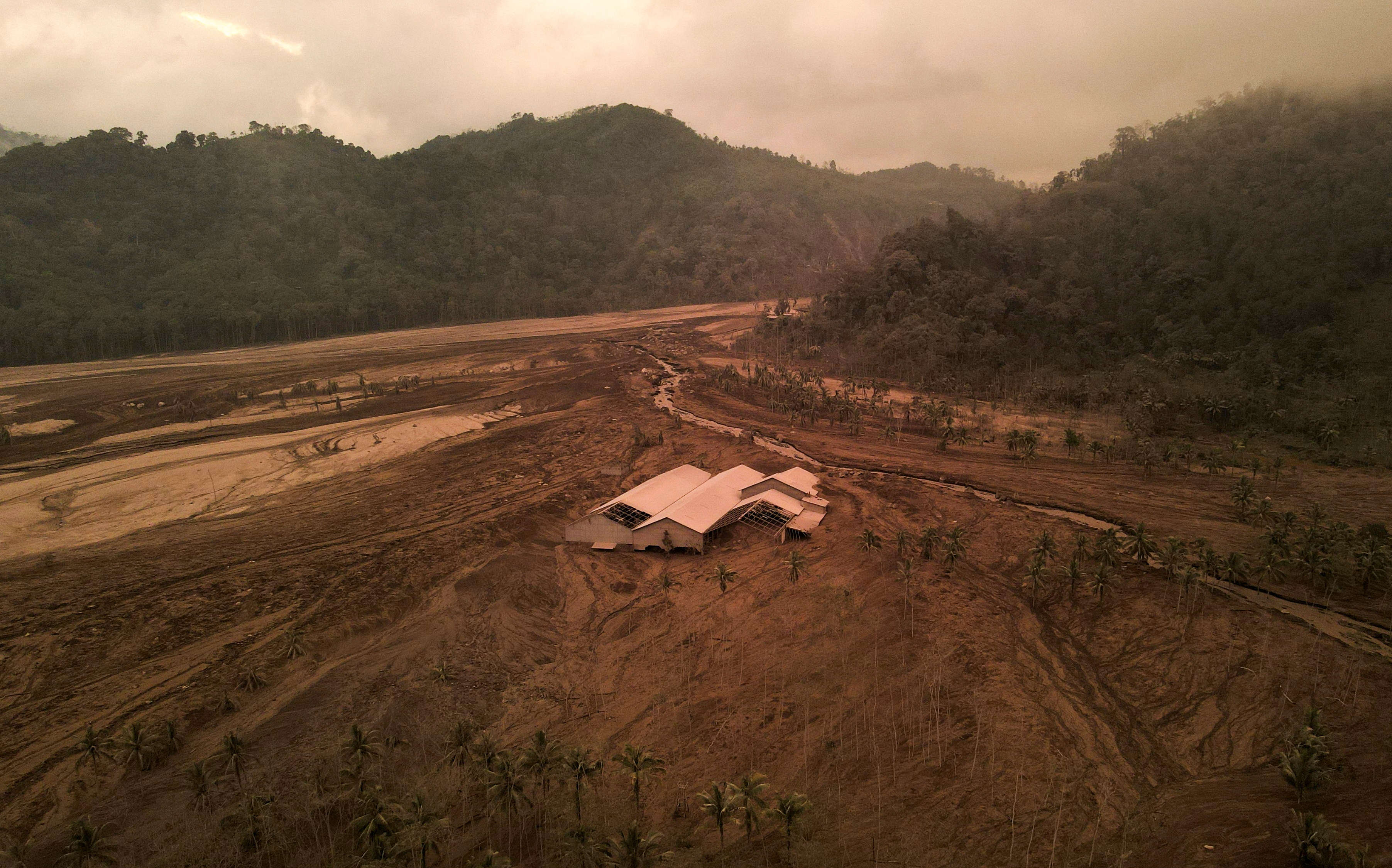 A damaged building is seen in an area affected by the eruption of Mount Semeru volcano in Candipuro district, Lumajang, Indonesia, December 7, 2021. Picture taken with a drone. REUTERS/Willy Kurniawan