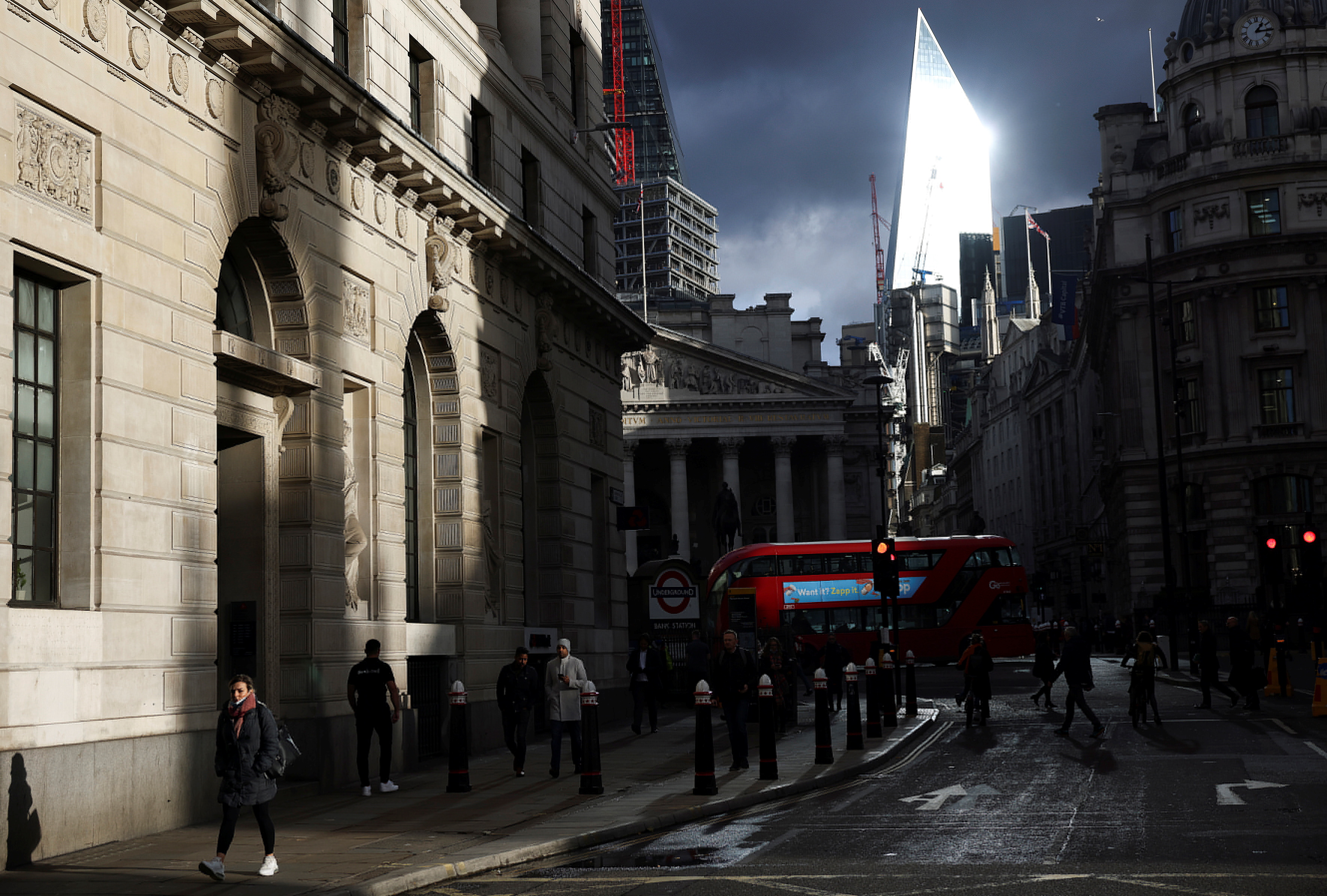People walk through the City of London financial district, amid the coronavirus disease (COVID-19) outbreak in London