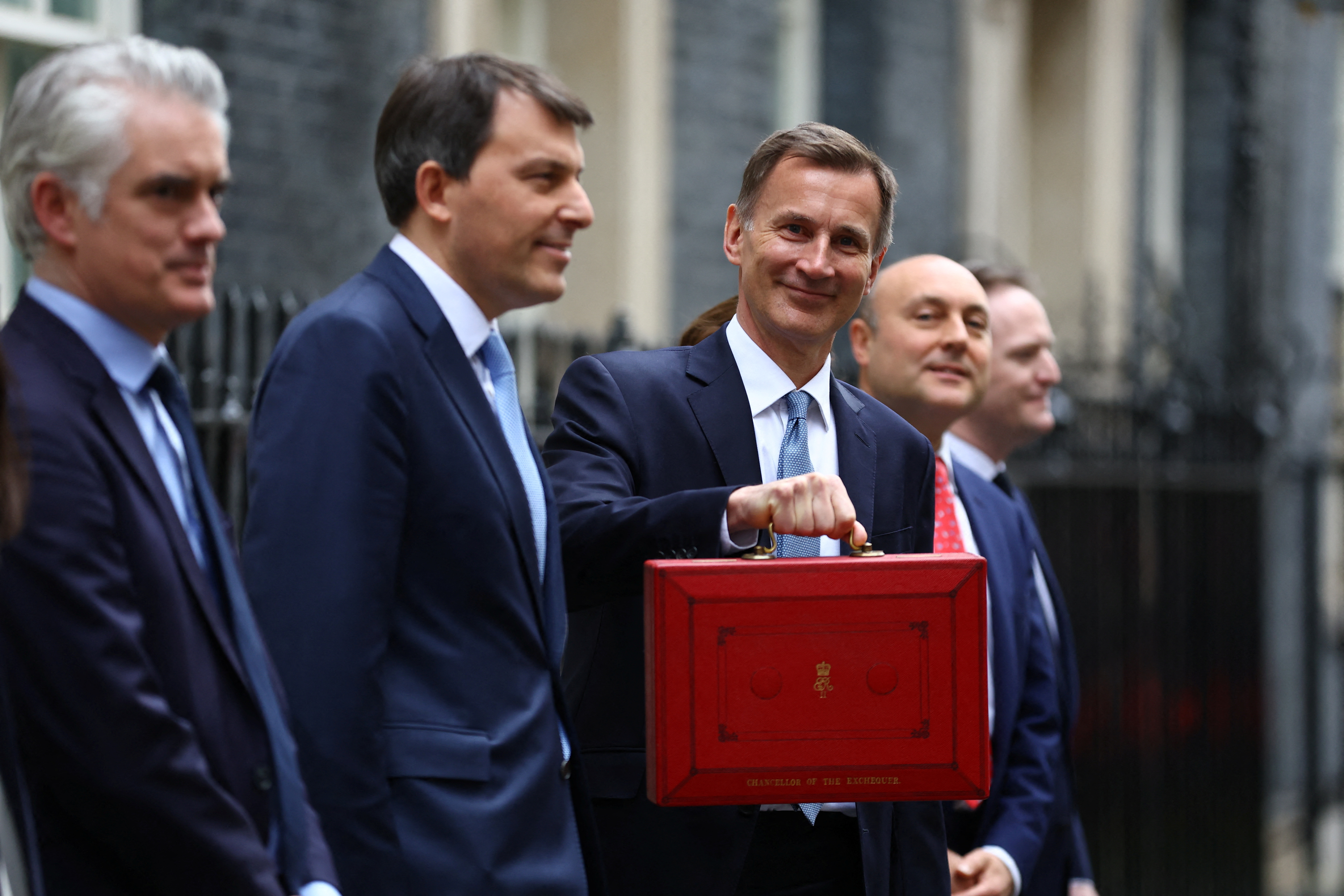 Chancellor of the Exchequer Hunt holds the budget box outside Downing Street in London