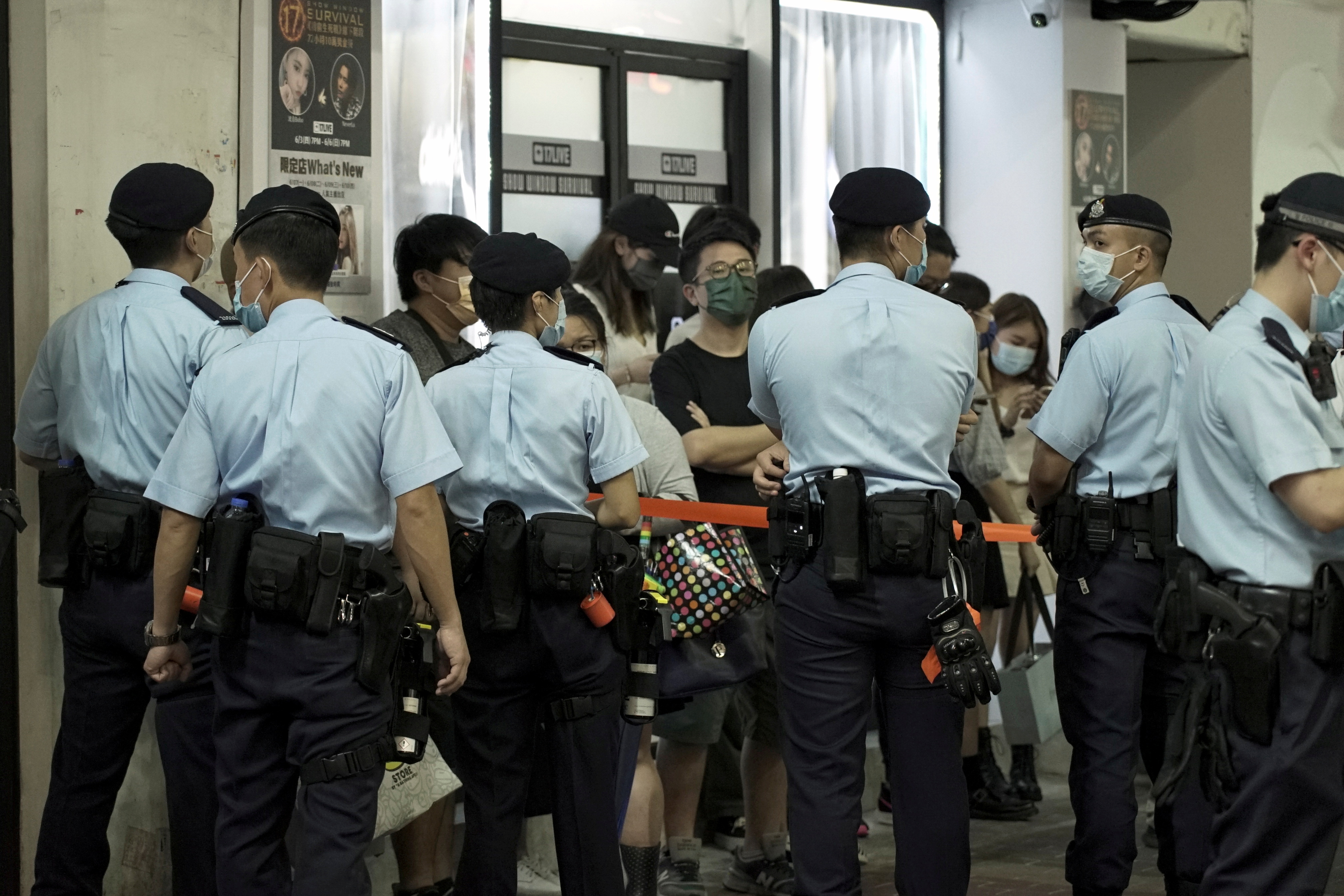 Police officers stop and search residents at Mong Kok district in Hong Kong