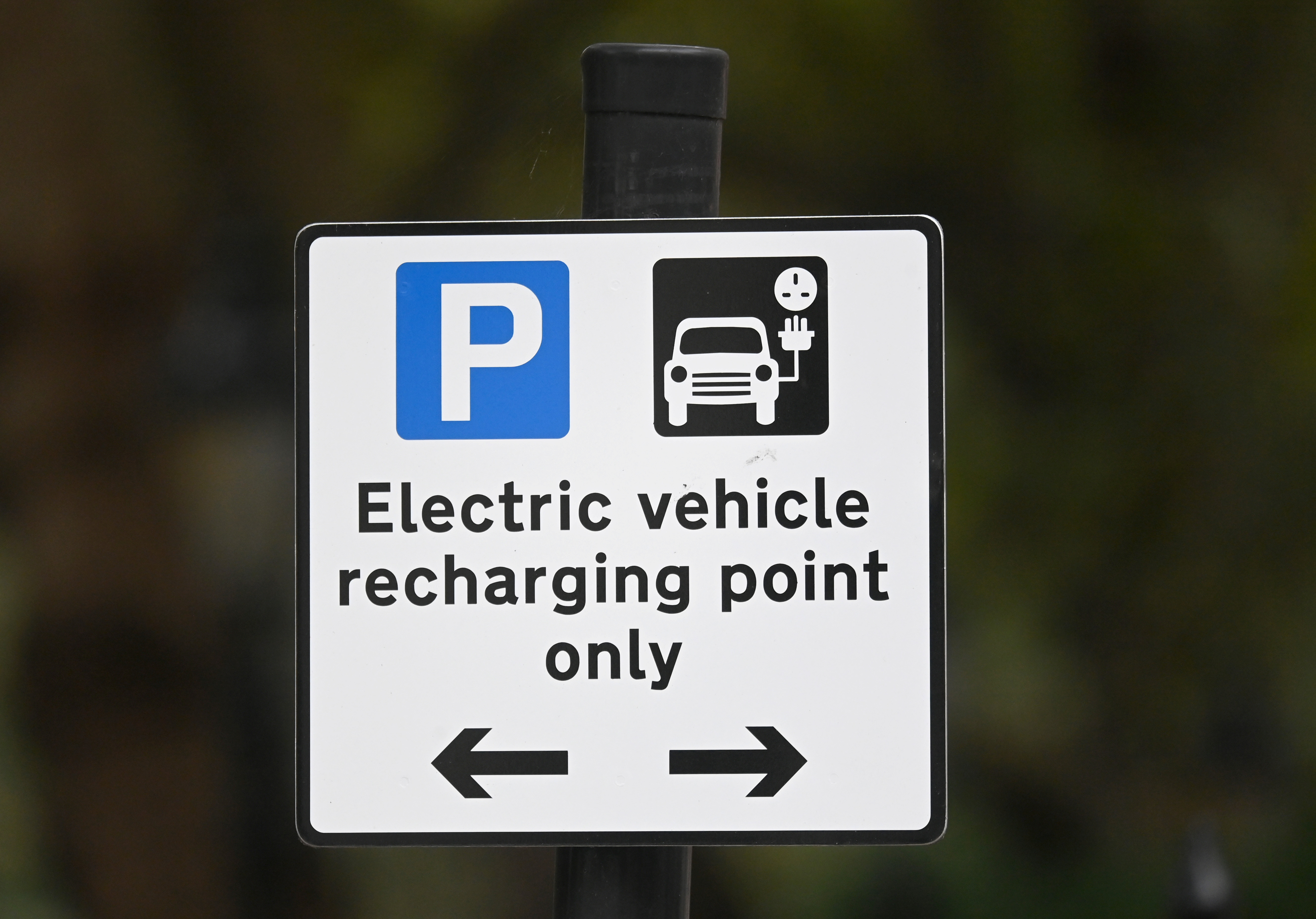 A roadside EV (electric vehicle) charge point sign is seen in London