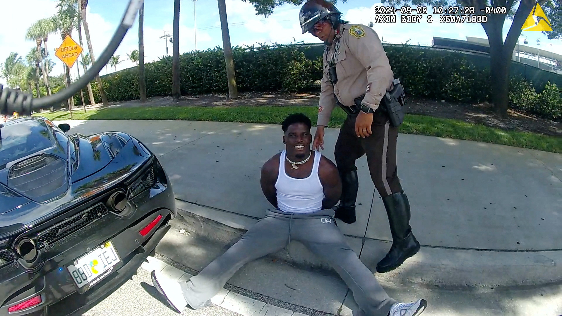 Miami Dolphins receiver Tyreek Hill is forced from his vehicle by Miami-Dade Police Department officers in Miami