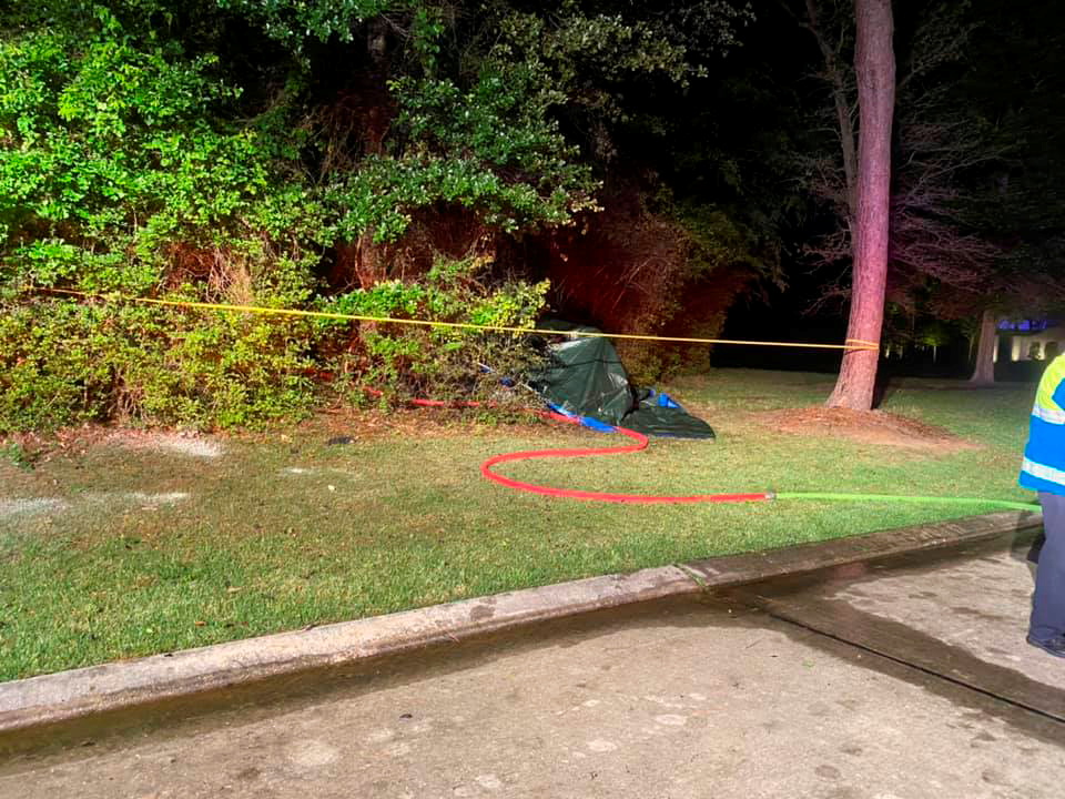 A Tesla vehicle is covered in tarp after it crashed in The Woodlands, Texas