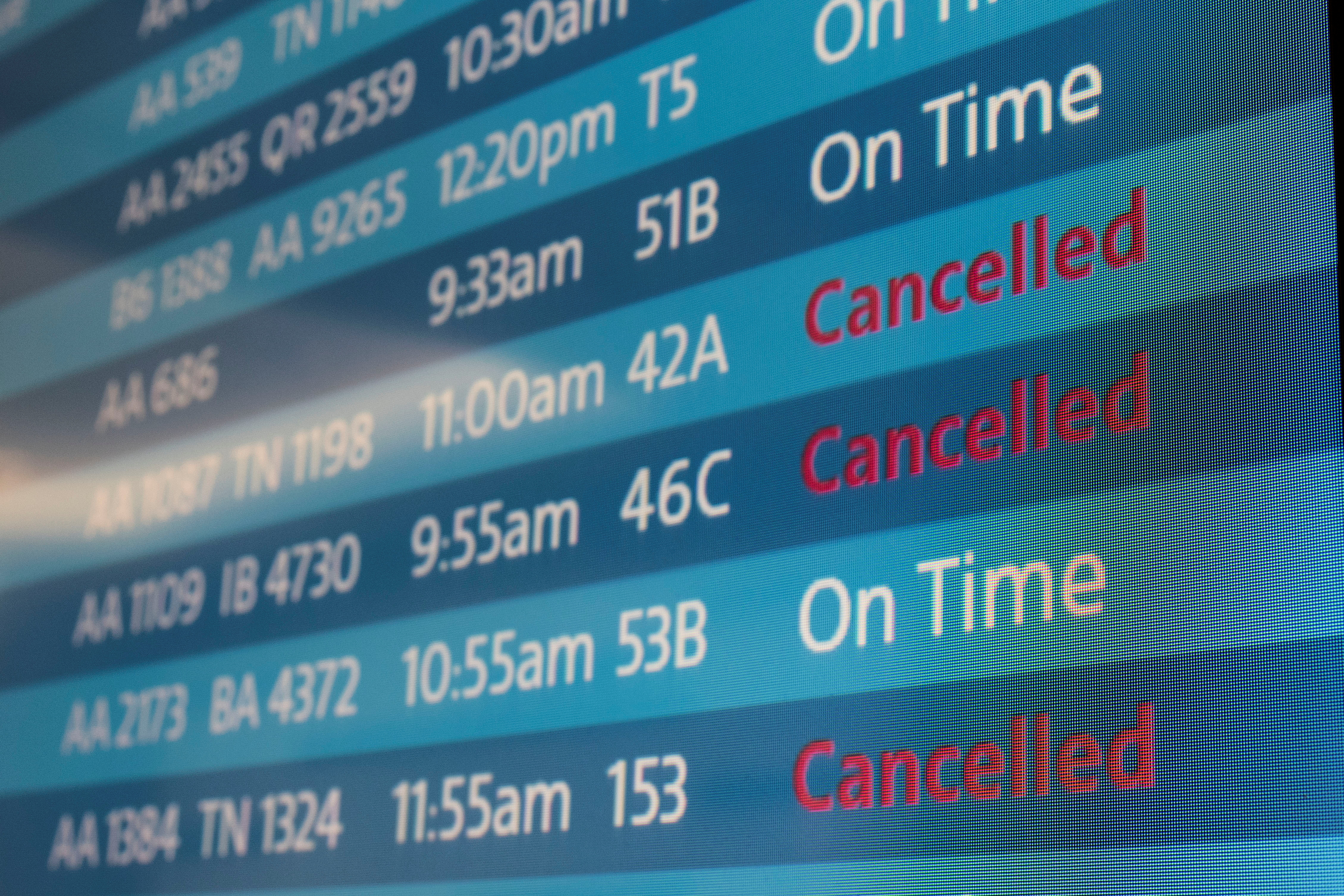 A screen showing cancelled flights as more than 1,400 American airlines have been canceled due to staff shortages and unfavorable weather in Los Angeles, California, U.S.