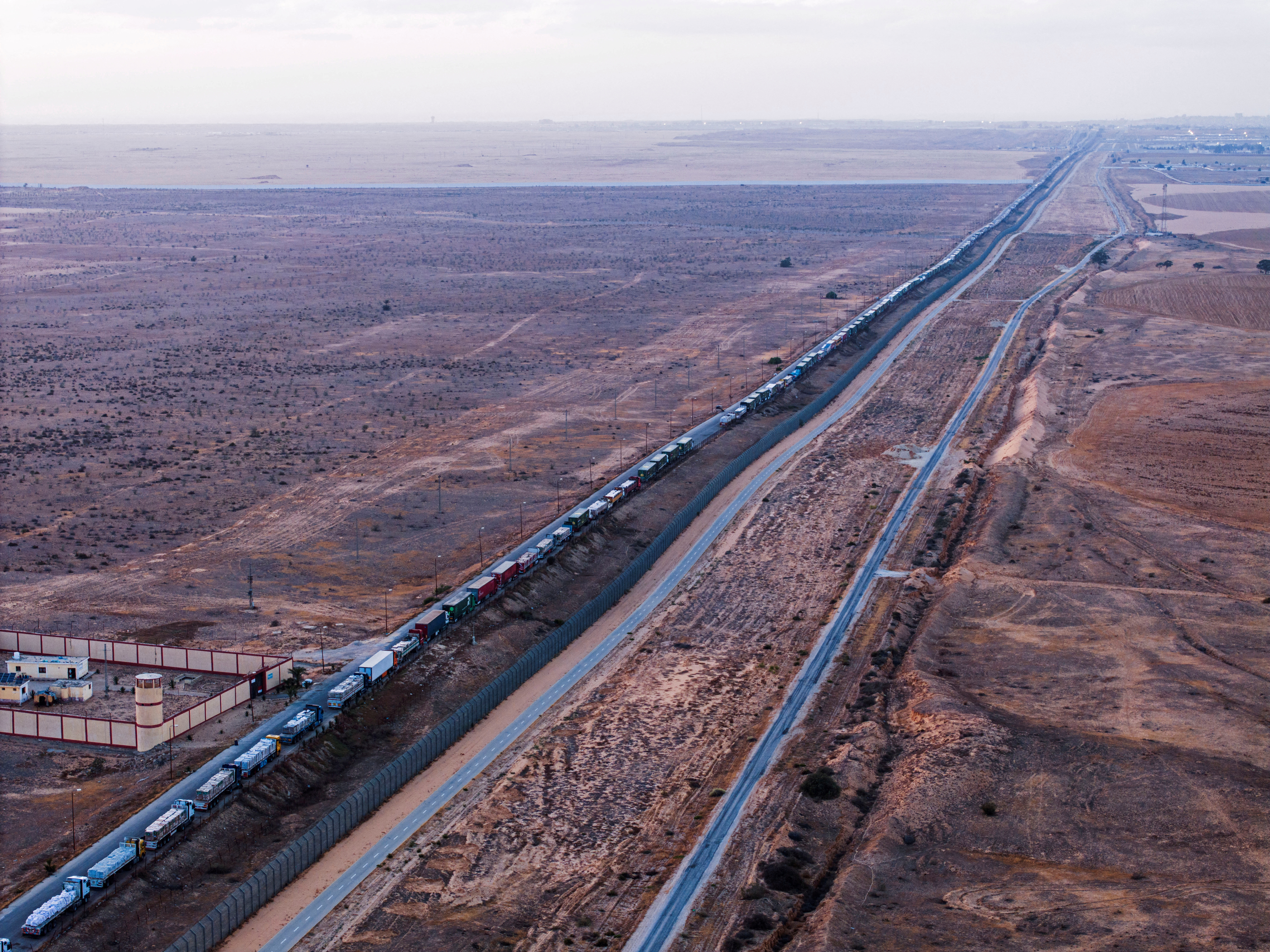 A drone picture of a line of trucks waiting on an Egyptian road along the border with Israel, near the Rafah border crossing with the Gaza Strip