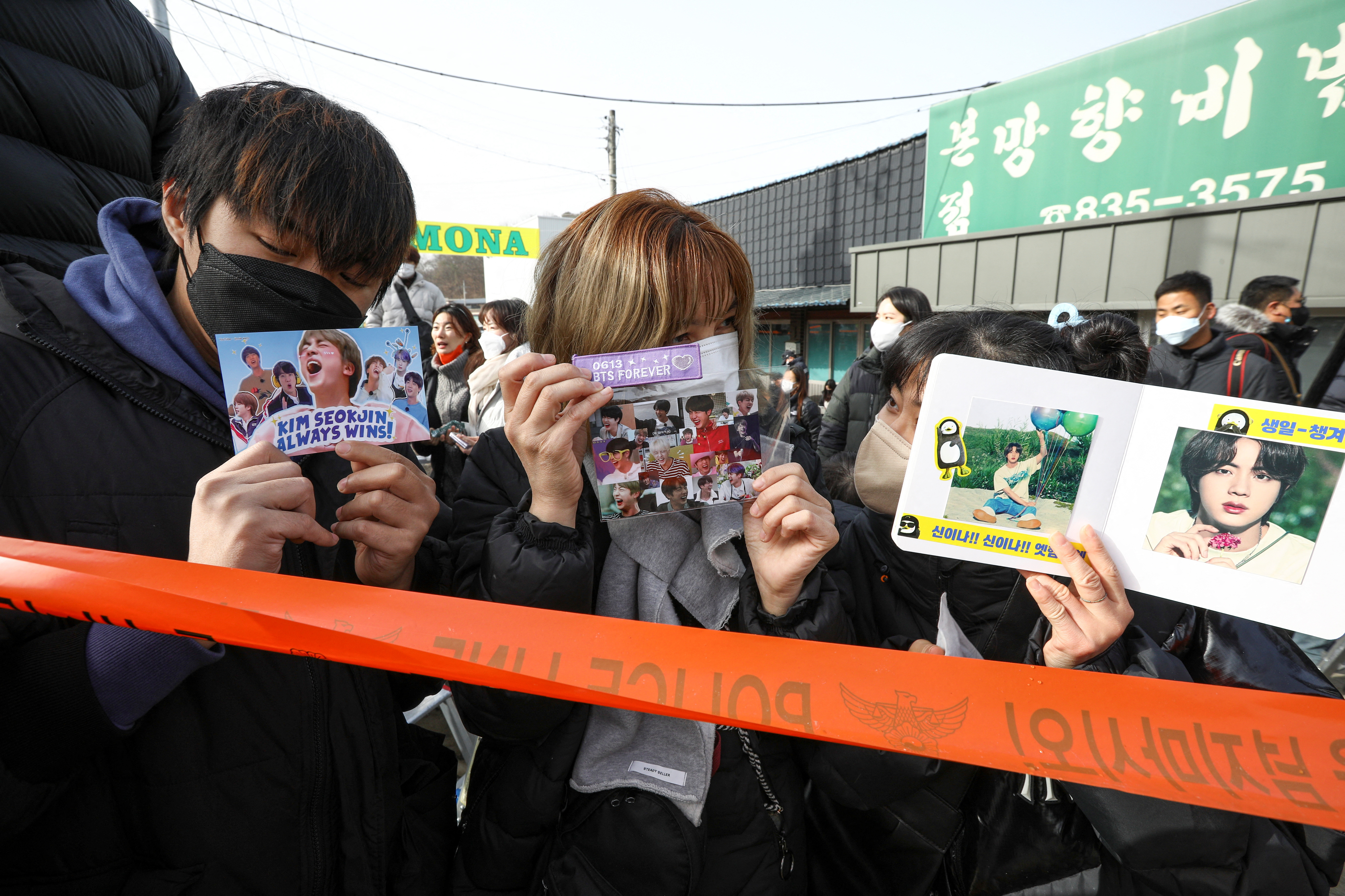 Fans wait outside a South Korean army boot camp where K-pop star and BTS member Jin begins military service, in Yeoncheon