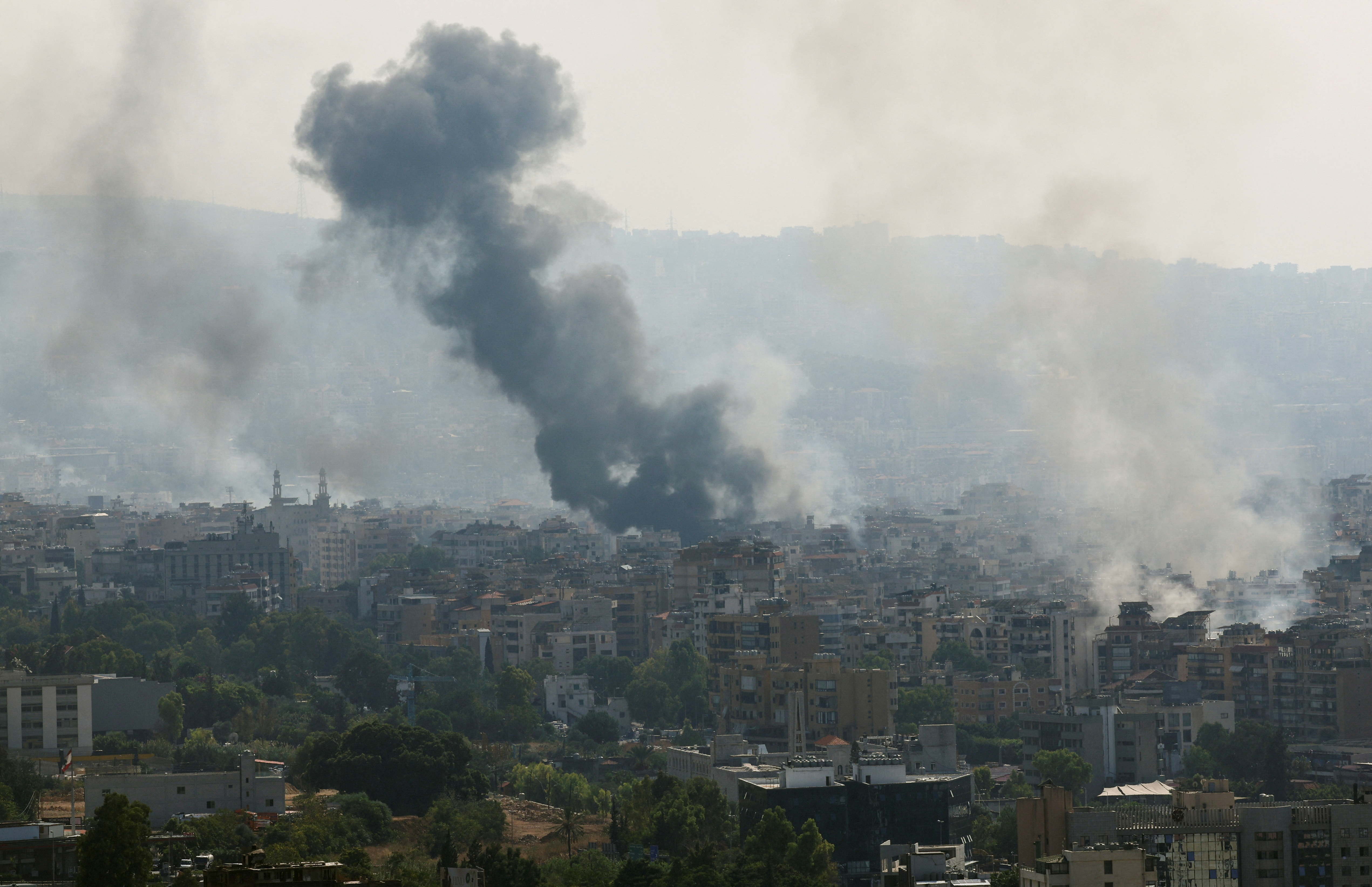 Smoke billows over Beirut's southern suburbs, as seen from Sin El Fil