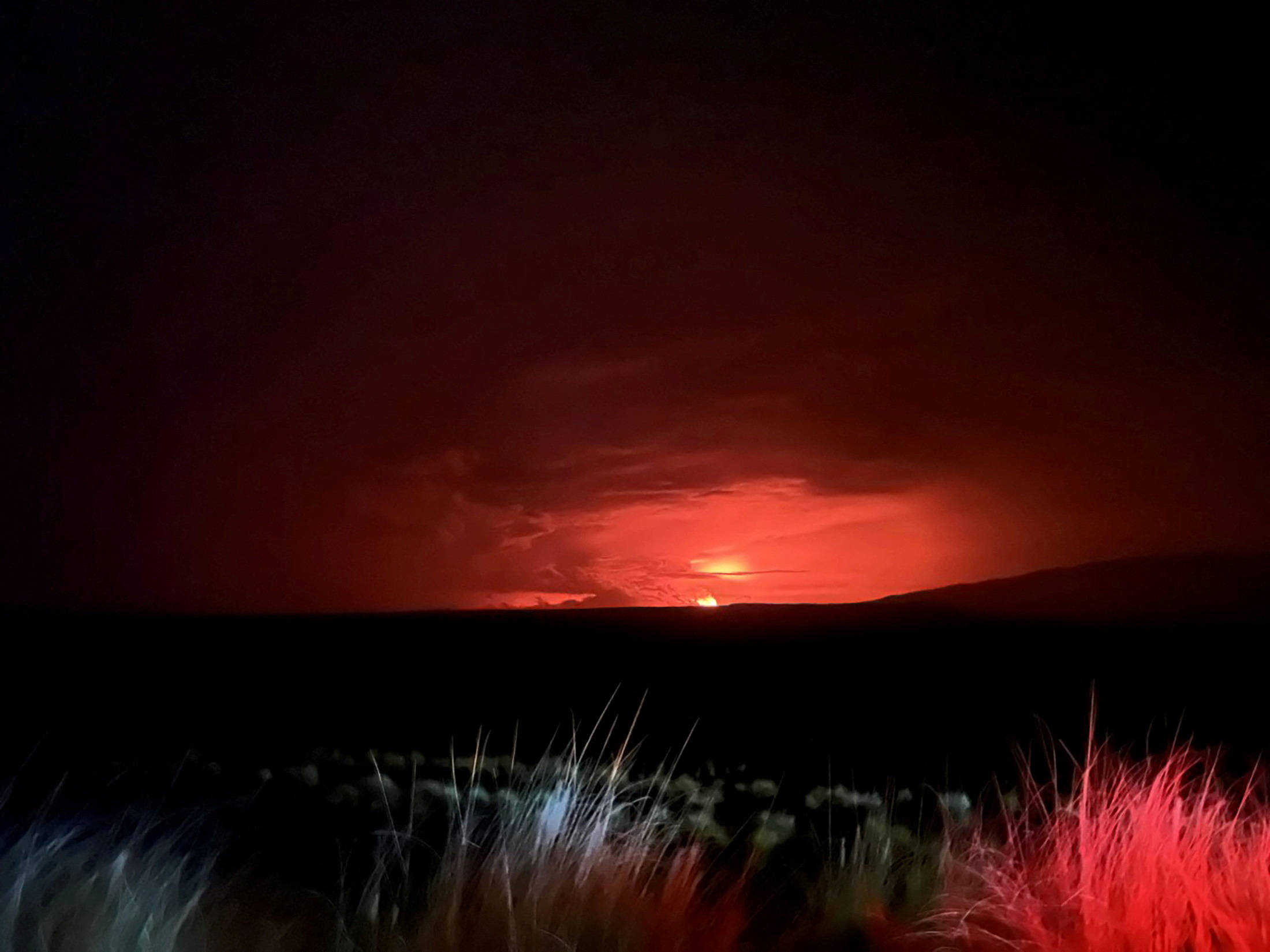 Mauna Loa’s summit region glows during an eruption as viewed by a geologist of the Hawaiian Volcano Observatory