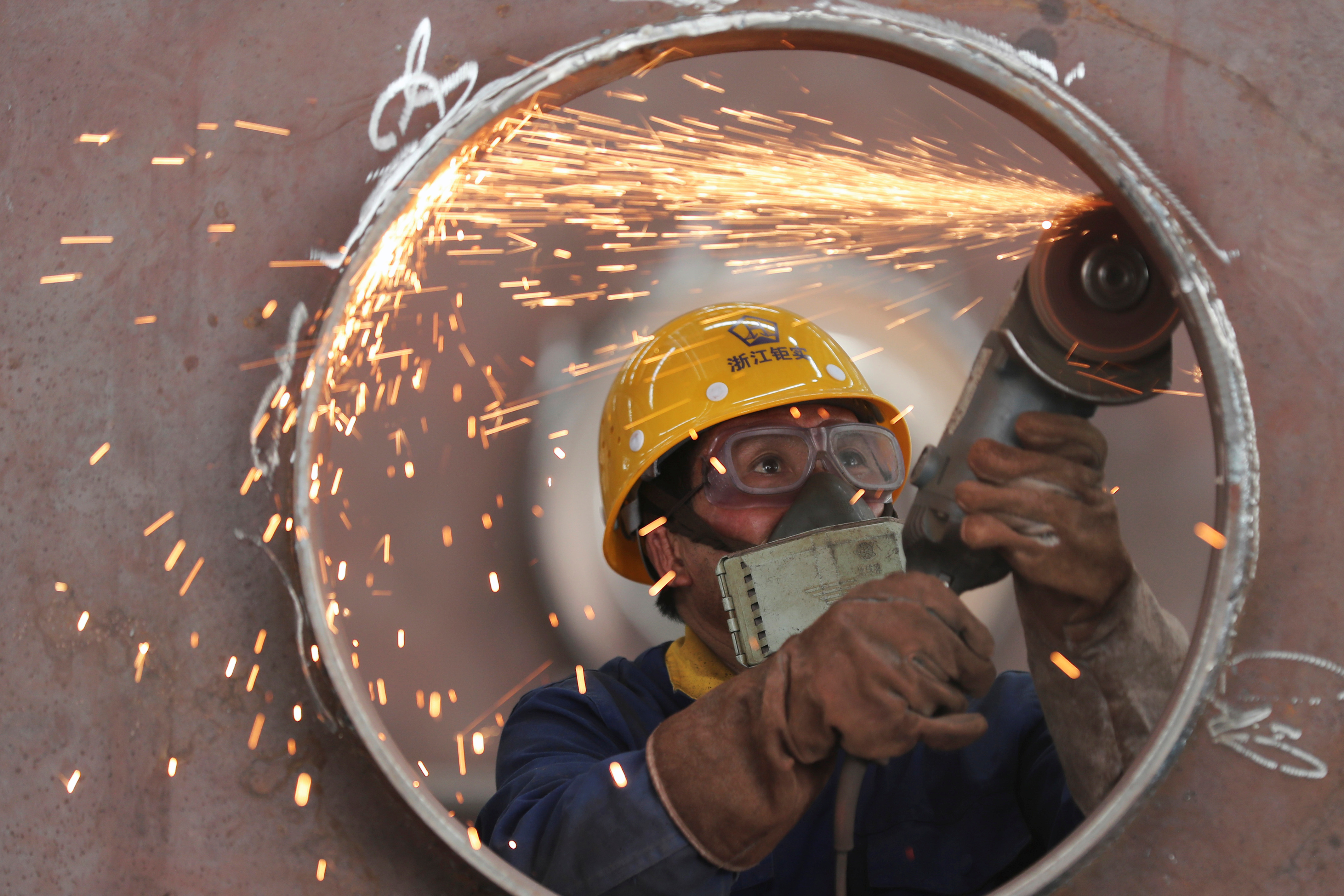 Employees work on a production line manufacturing steel structures at a factory in Huzhou City.