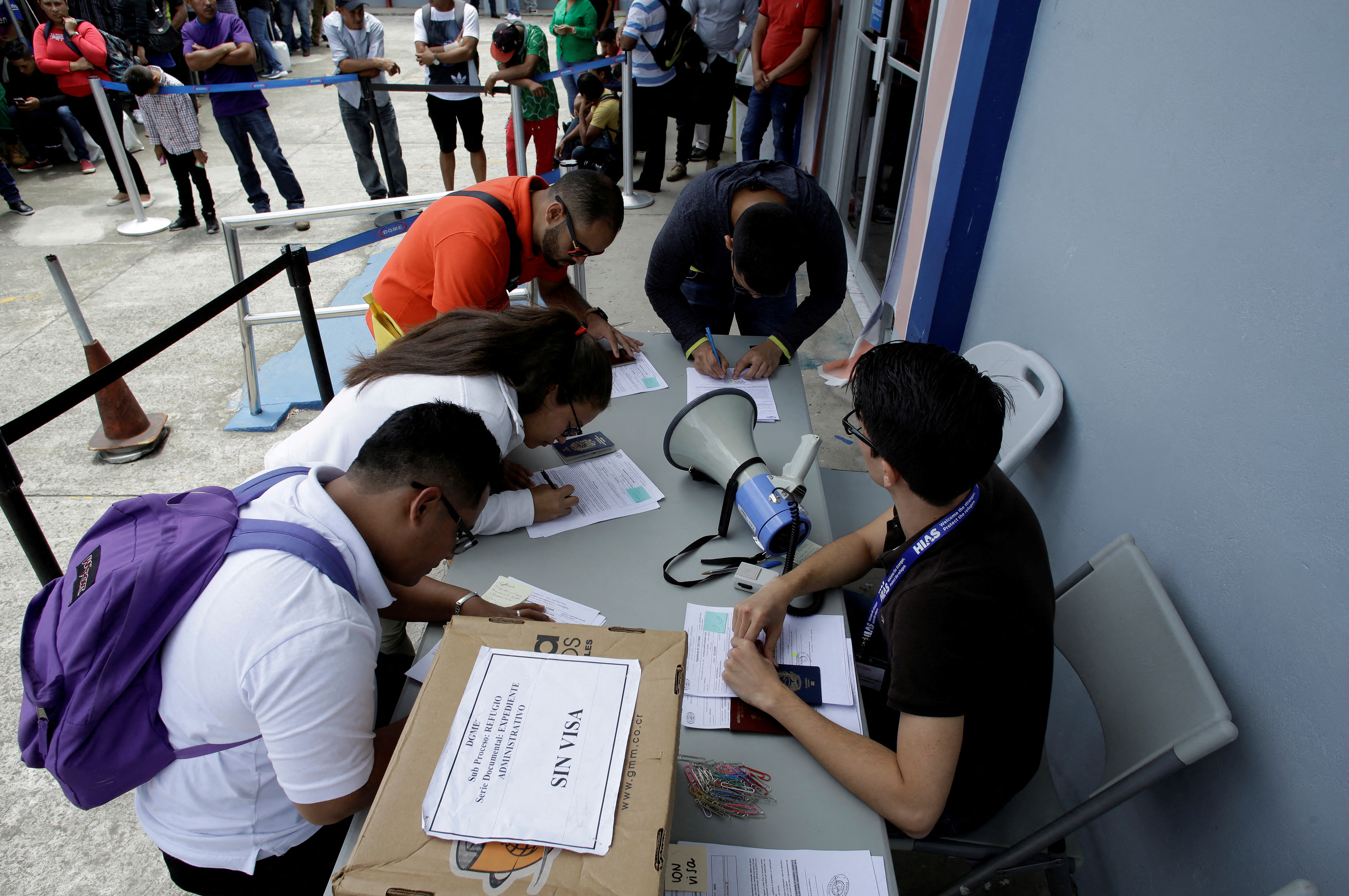 Nicaraguan migrants fill documents to request refuge in Costa Rica due to the unrest occurring in their country at the migration office in San Jose, Costa Rica