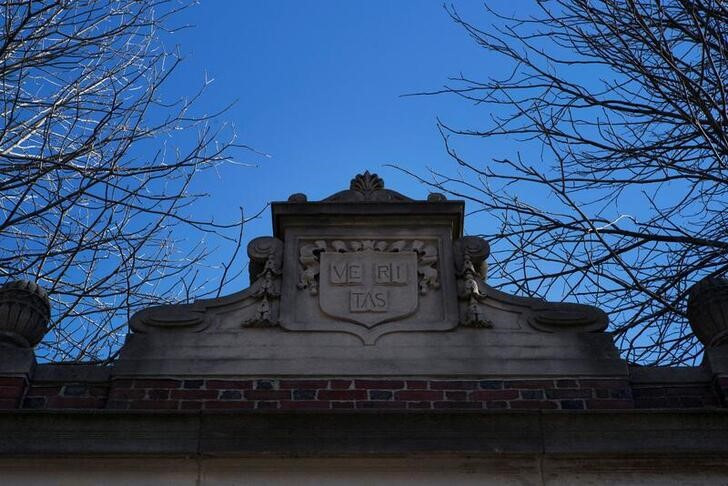 The Harvard College arms sits atop a gate into Harvard Yard at Harvard University in Cambridge