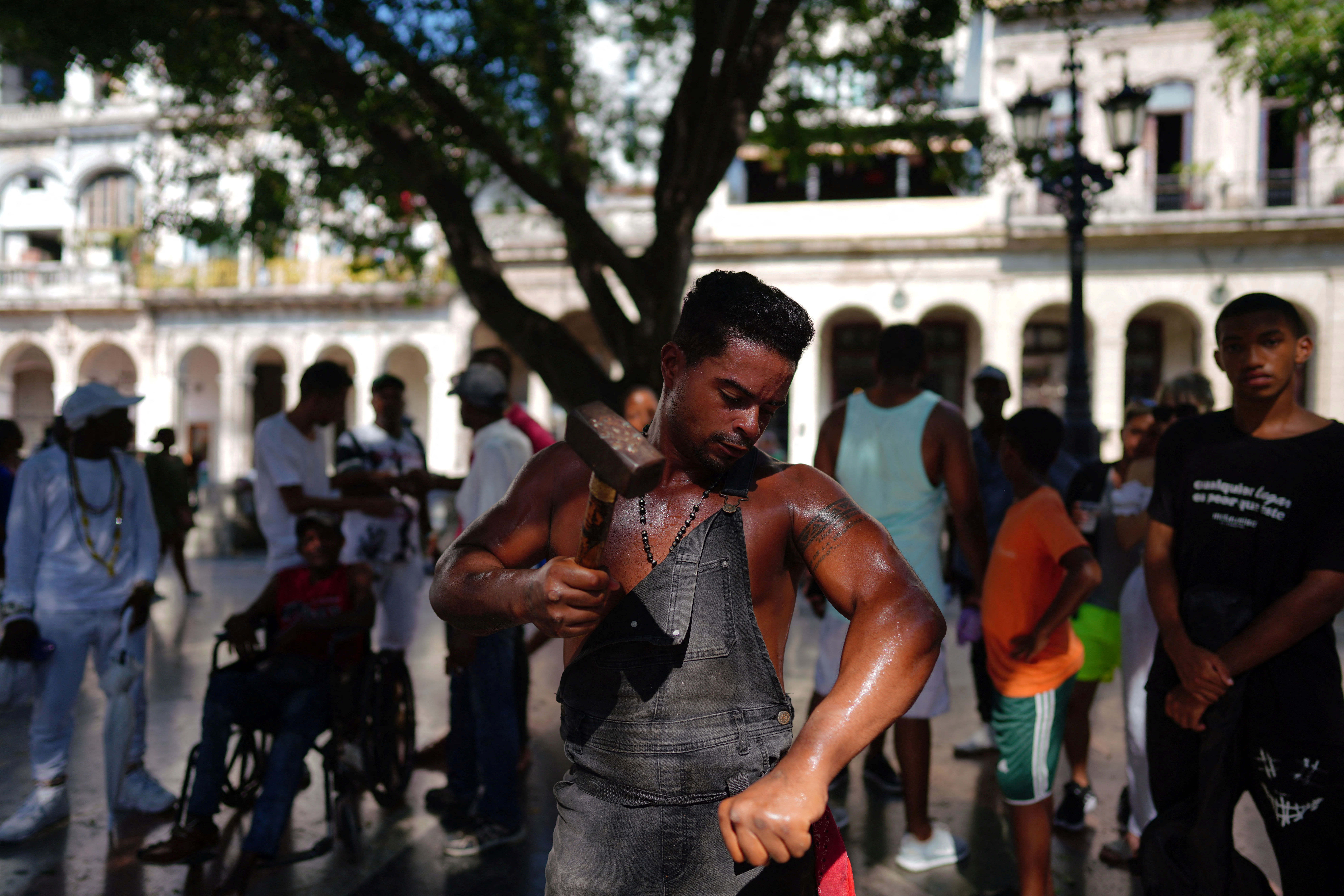 Cuba's "Ironman" Lino Tomasen performs in downtown Havana