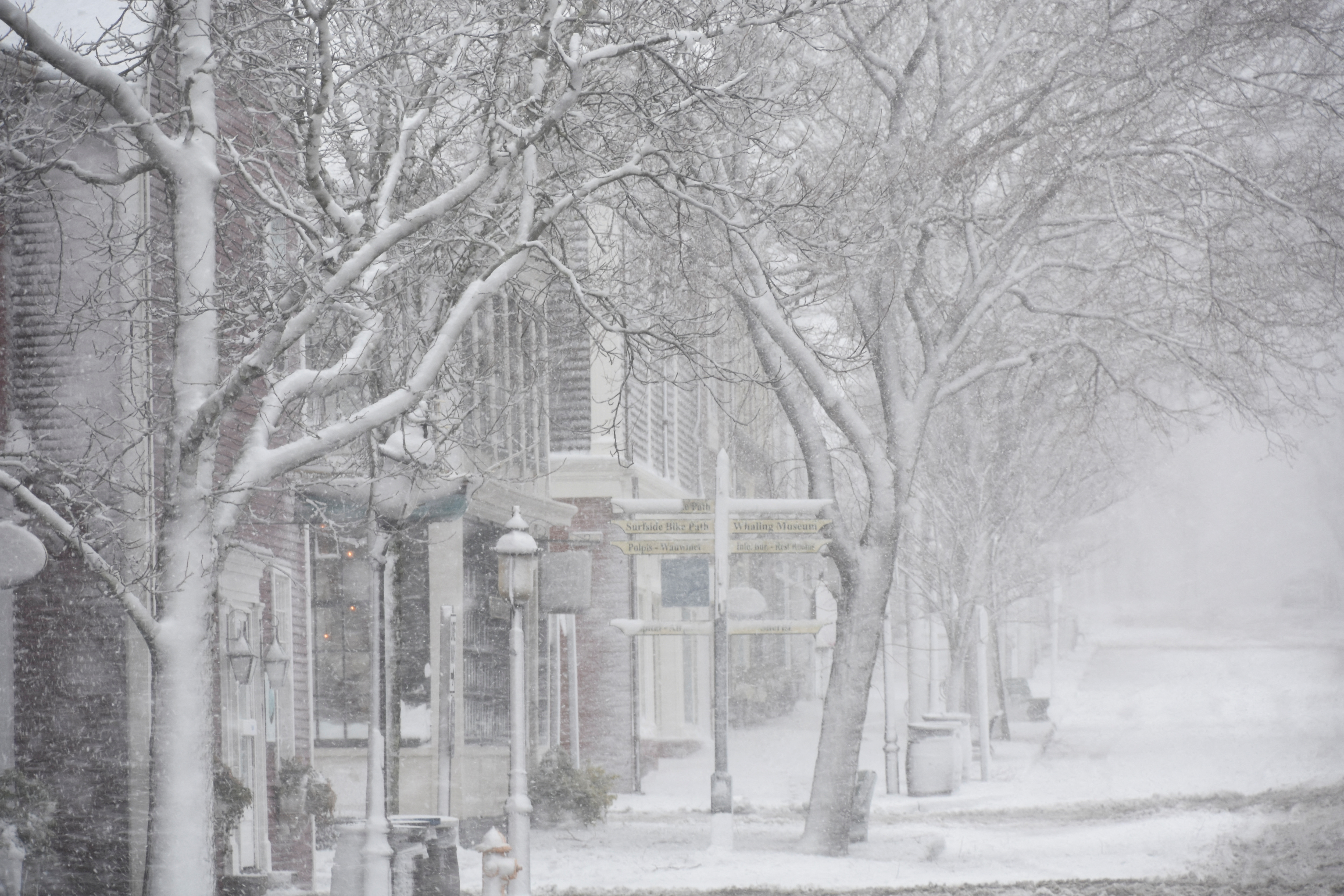 A view of buildings and a street covered in snow in Nantucket