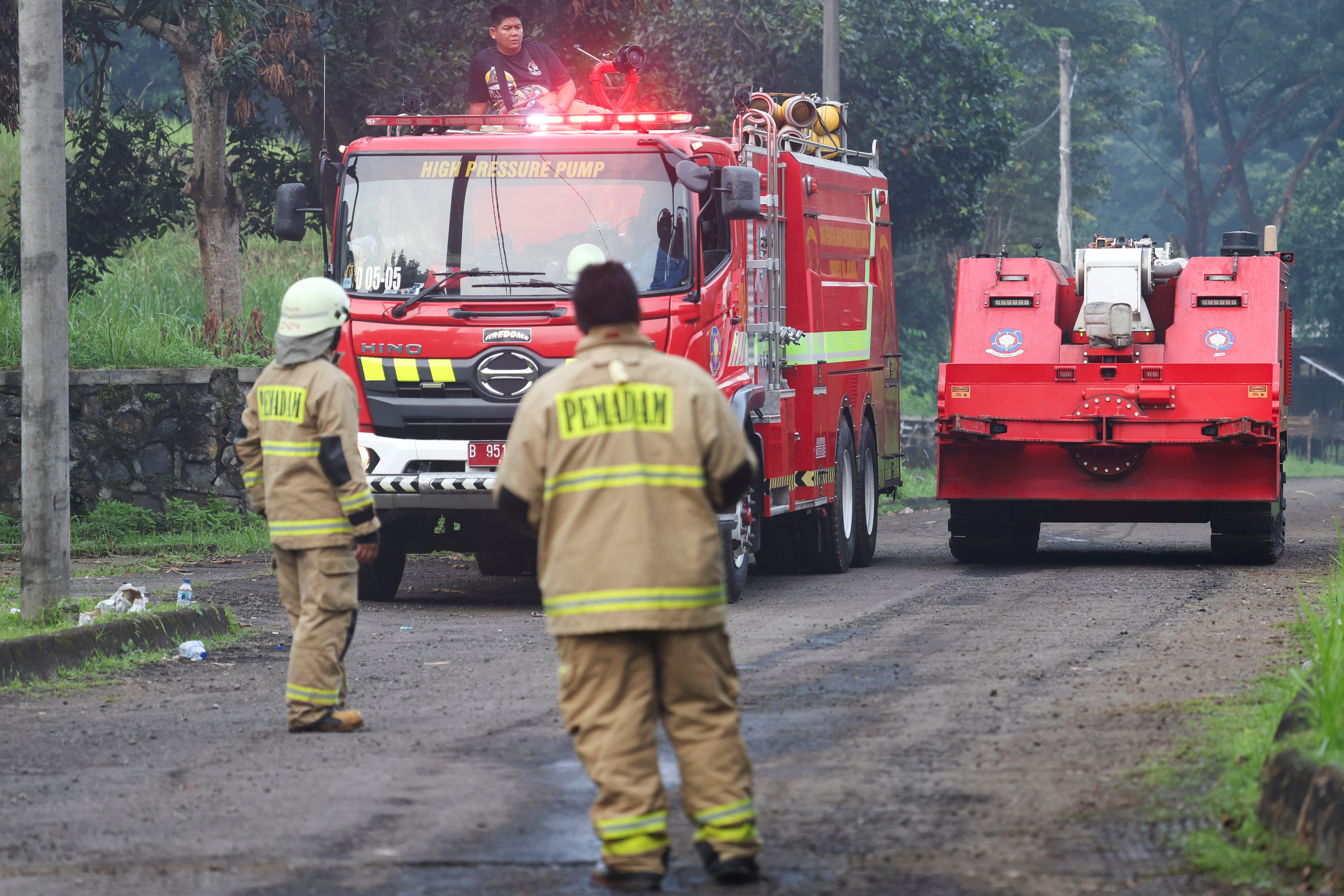 A firefighting robot passes after a massive fire broke out at a military ammunition facility in Bogor