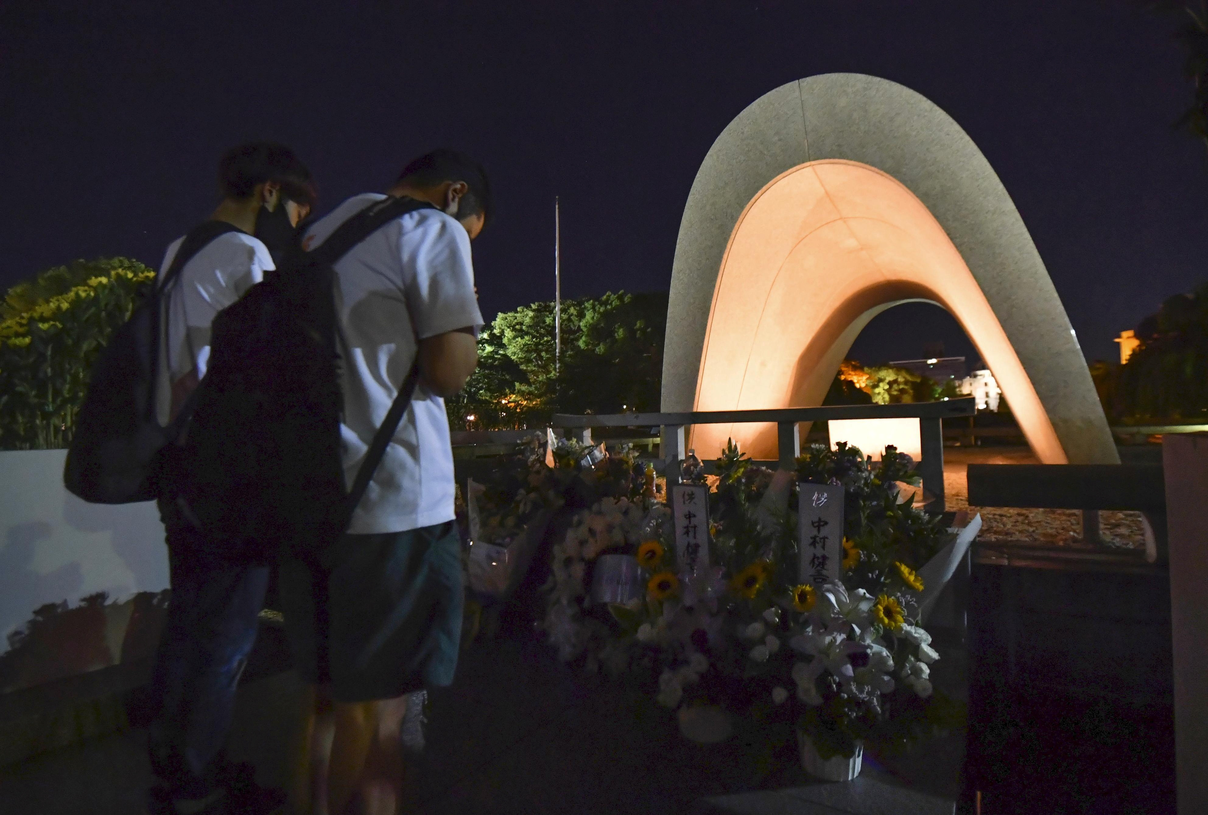 FILE PHOTO - People pray in front of the cenotaph for the victims of the 1945 atomic bombing, at Peace Memorial Park in Hiroshima