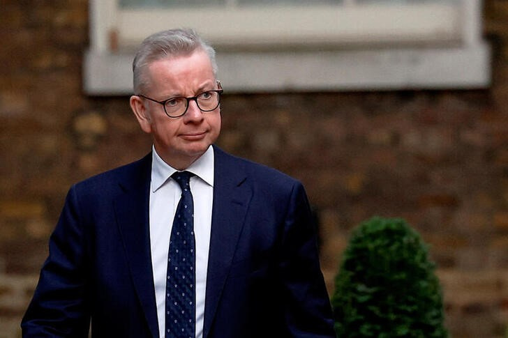 Michael Gove walks outside Number 10 Downing Street in London
