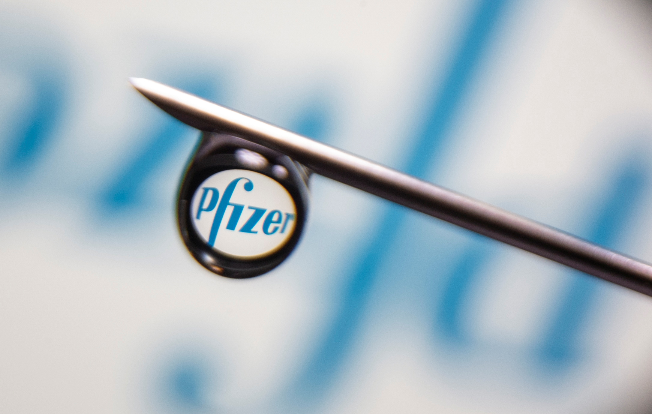 Pfizer logo is reflected in a drop on a syringe needle in this illustration photo taken March 16, 2021. Picture taken March 16, 2021. REUTERS/Dado Ruvic/Illustration