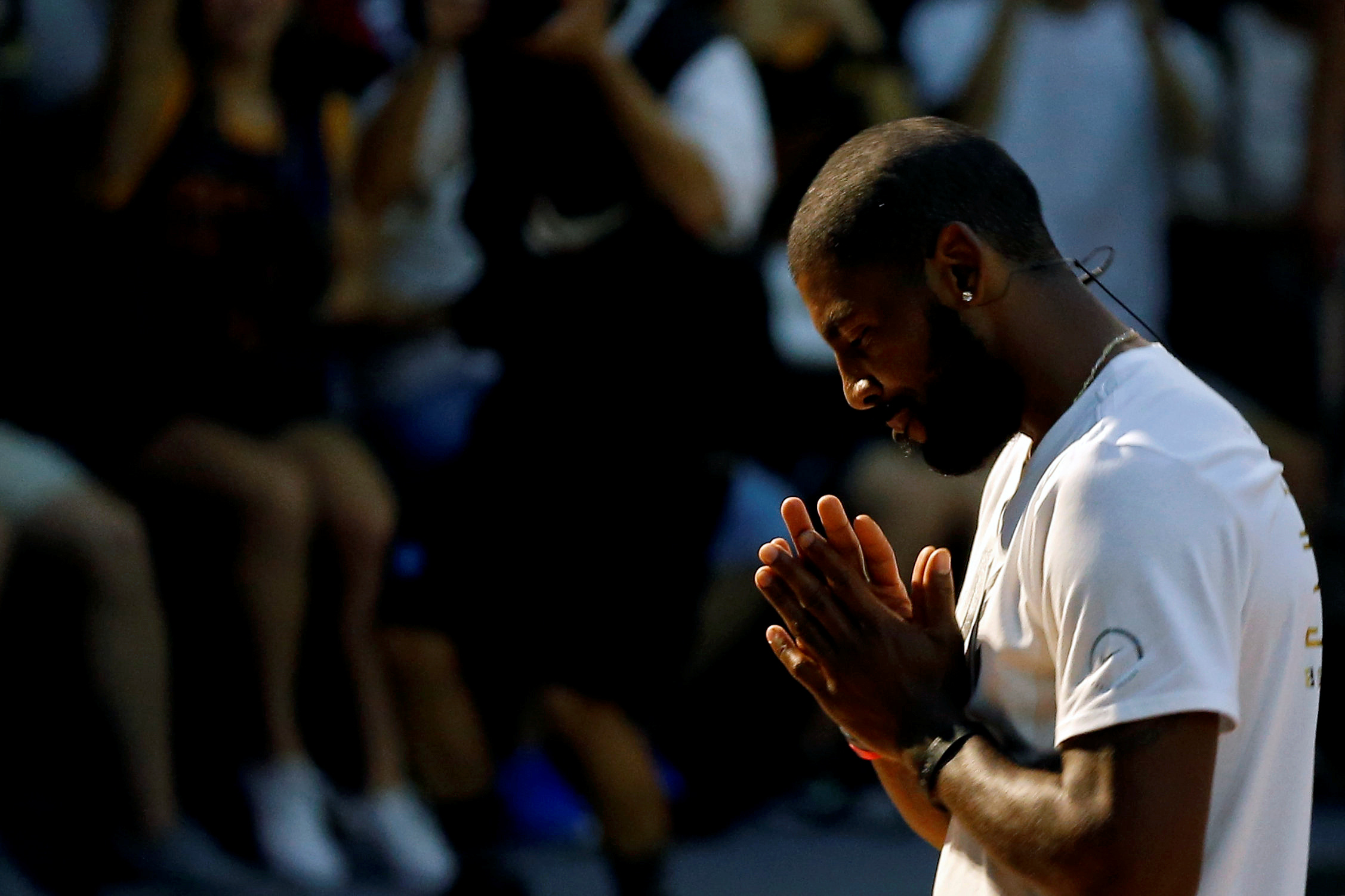NBA player Kyrie Irving of the Cleveland Cavaliers reacts during a promotional event in Taipei