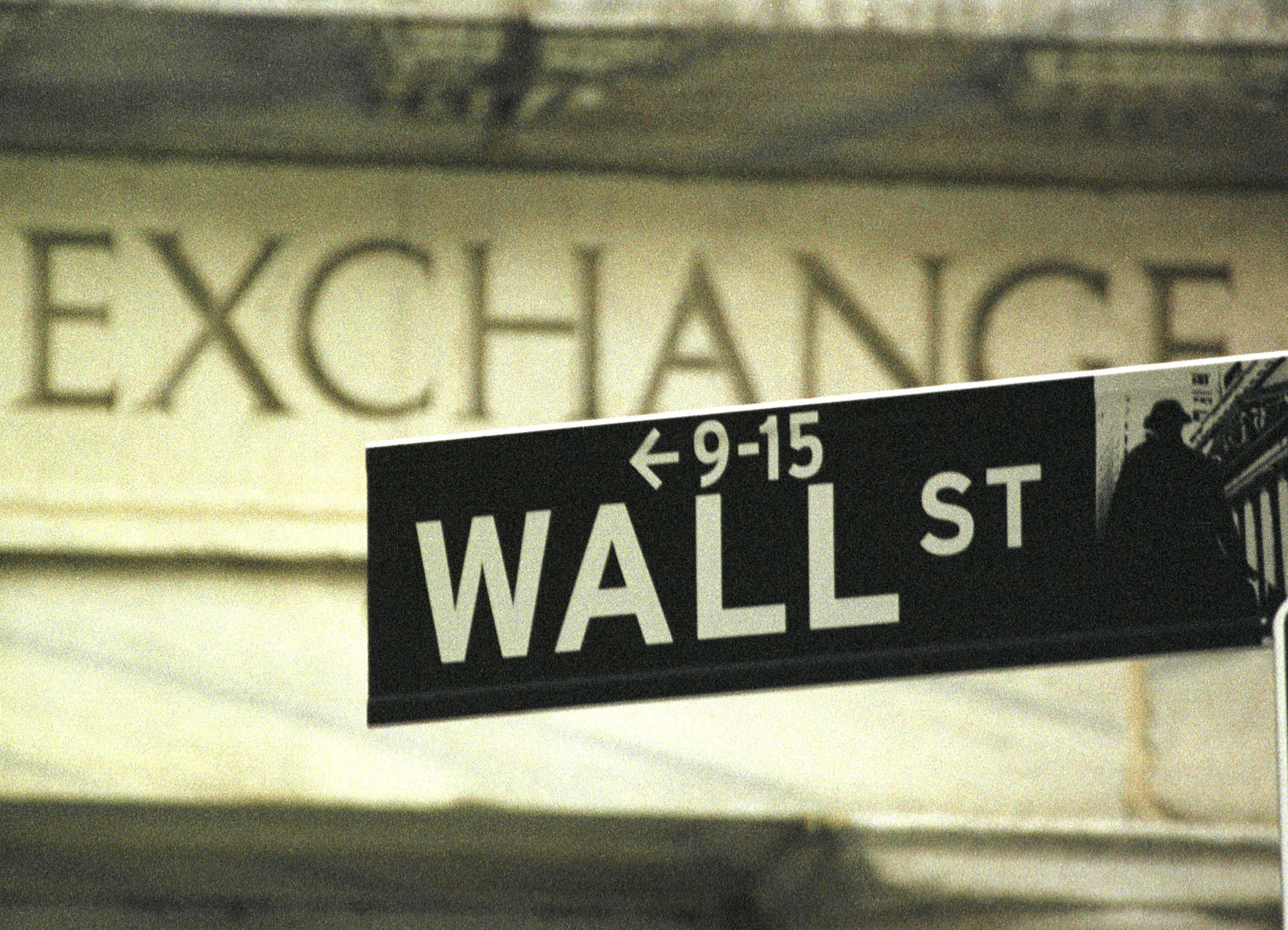A Wall Street street sign stands in front of the New York Stock Exchange in New York, picture taken September 21, 2000. MRKET  AKW/AS