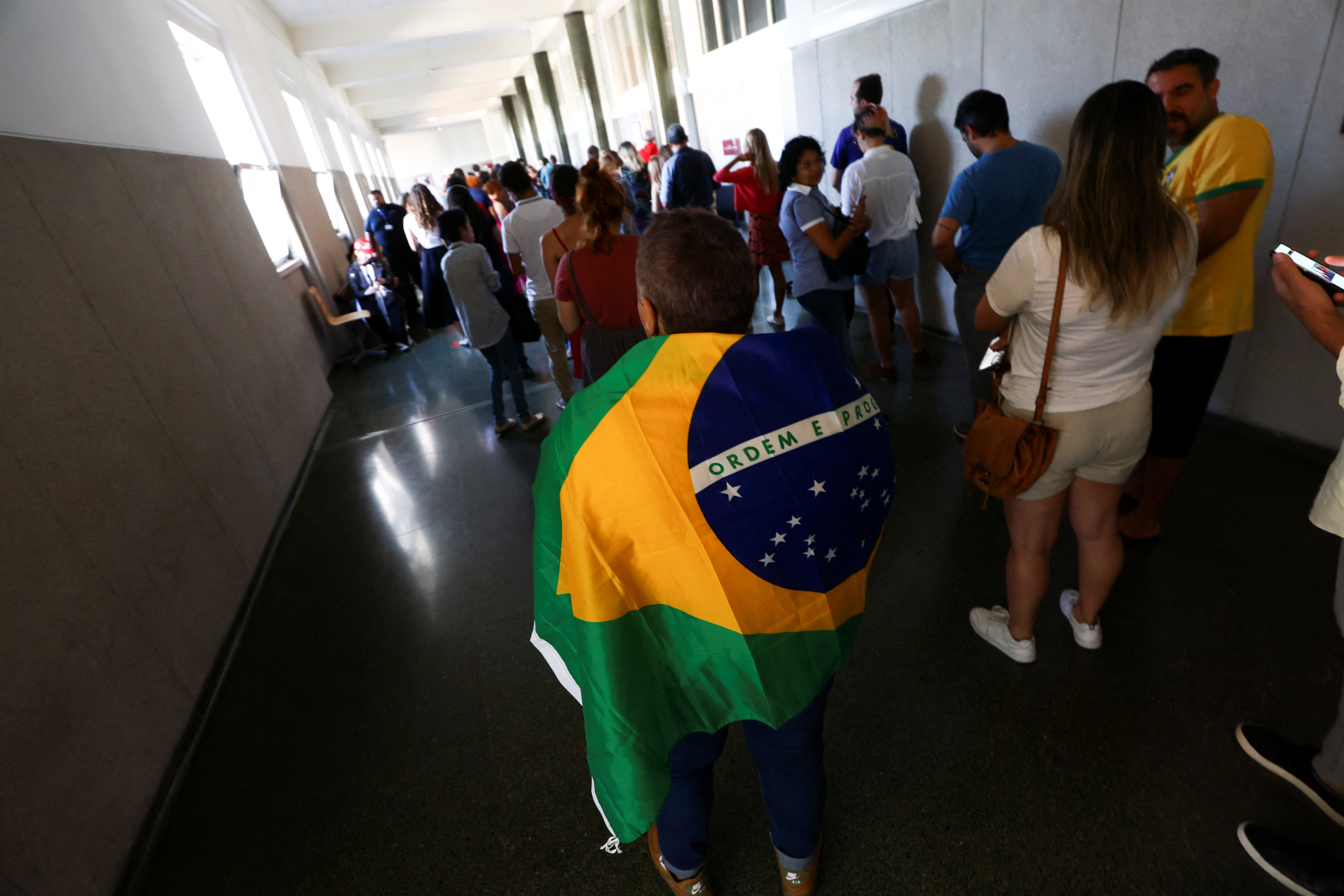 Citizens of Brazil wait in line to cast their vote in their country's election, in Lisbon