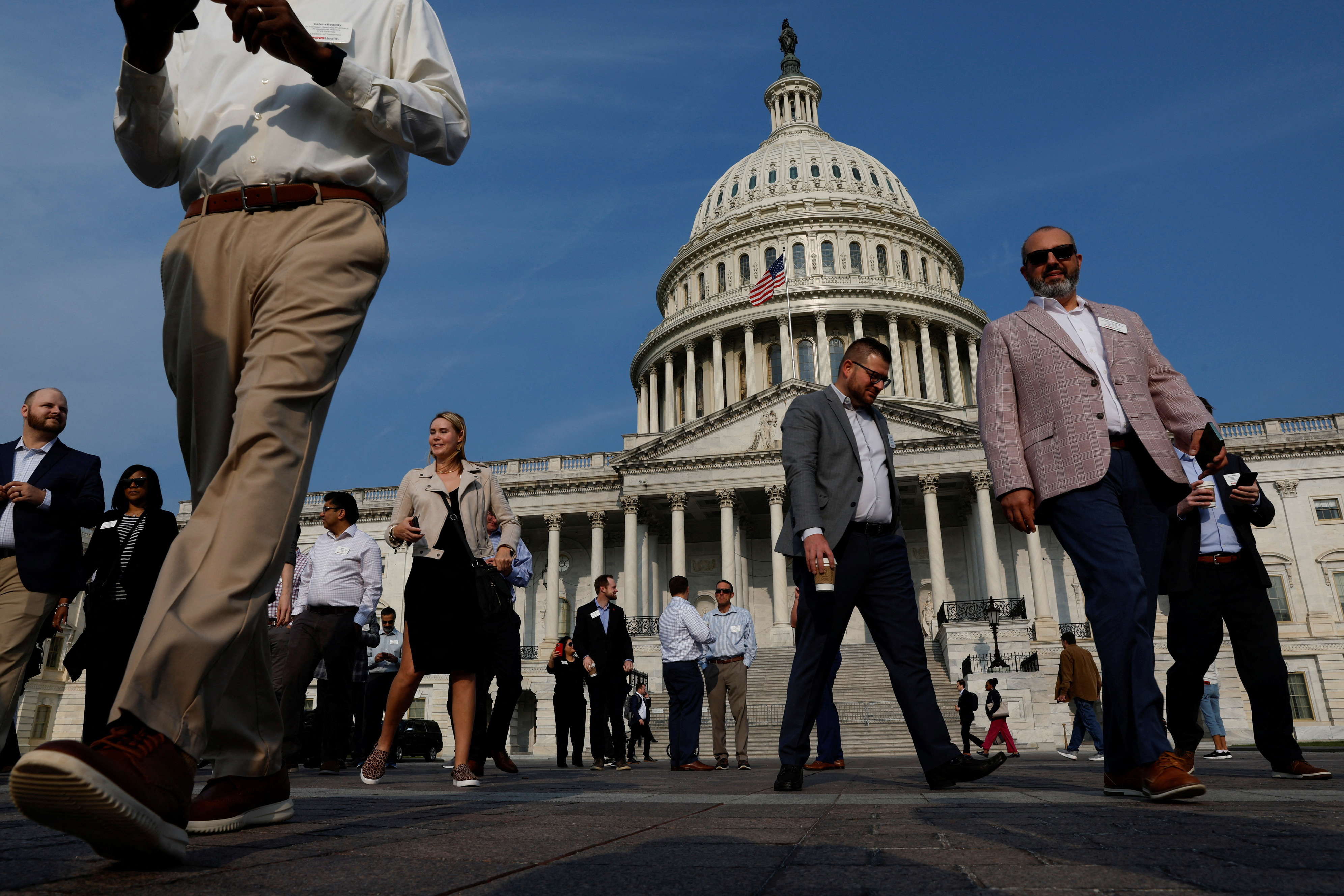 Visitors walk on the plaza at the U.S. Capitol in Washington