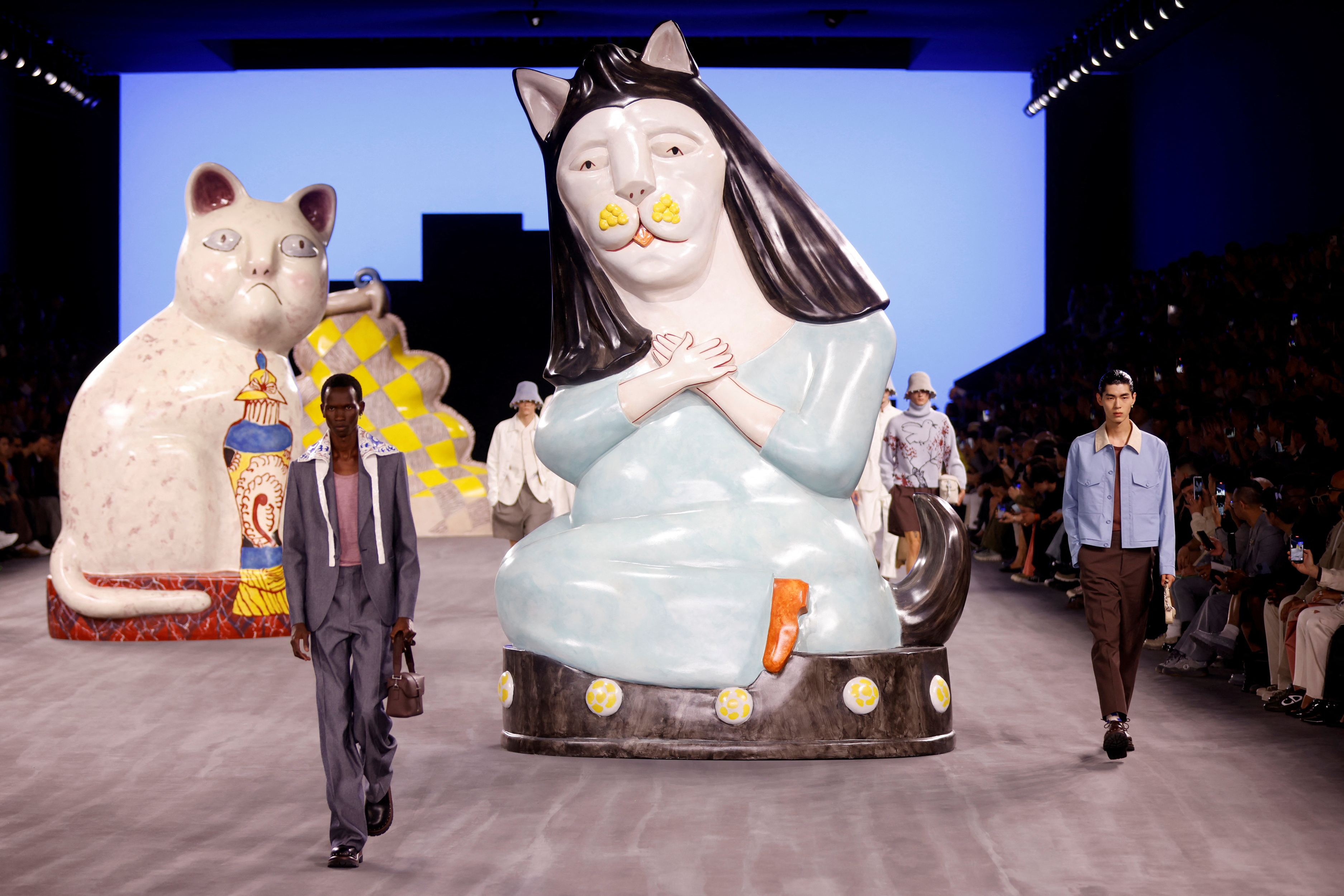 Giant cats stalk the catwalk at the Dior men's show | Reuters
