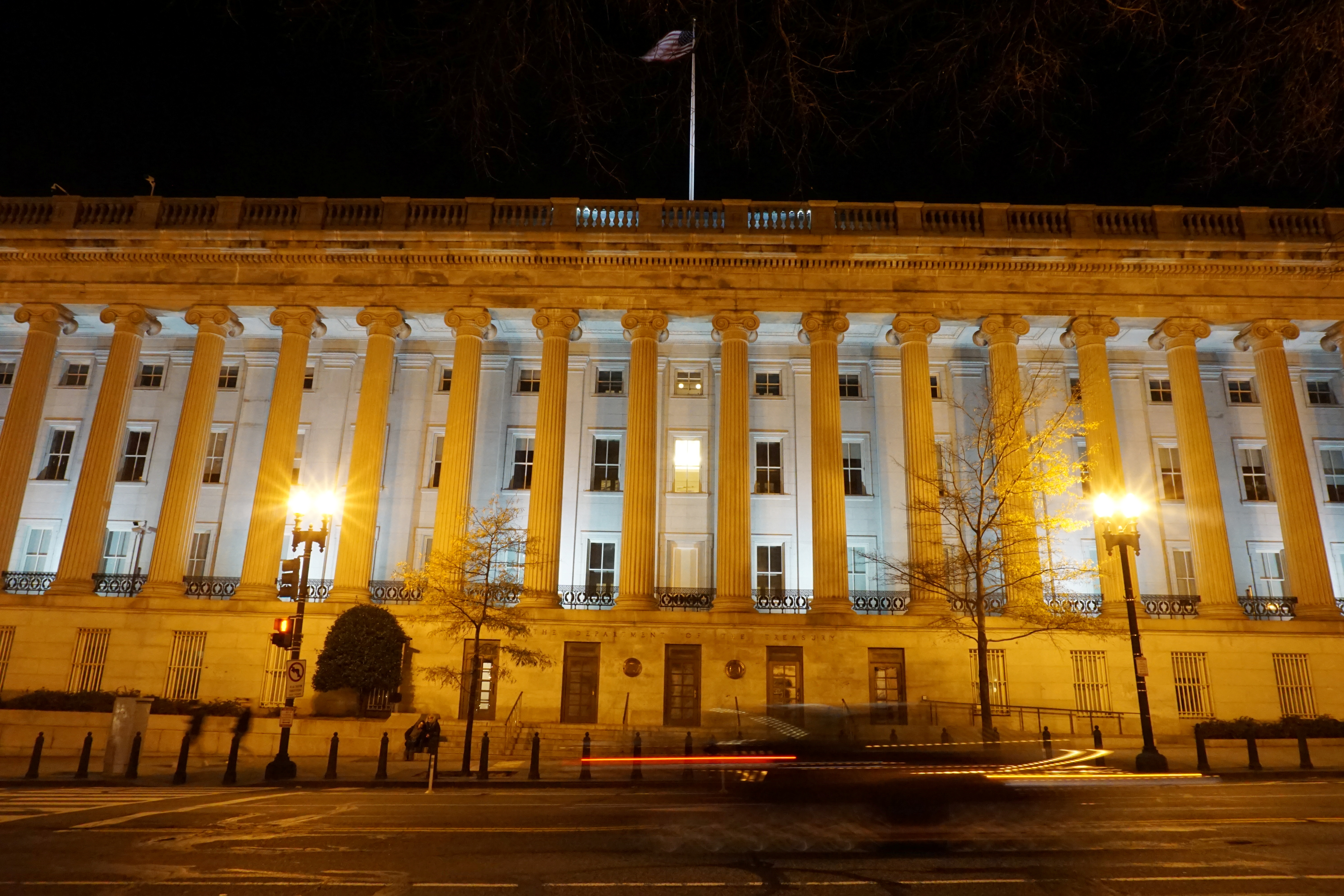 A vehicle drives past the U.S. Treasury Department in Washington, D.C., U.S. December 13, 2020. Picture taken with a long exposure. REUTERS/Raphael Satter