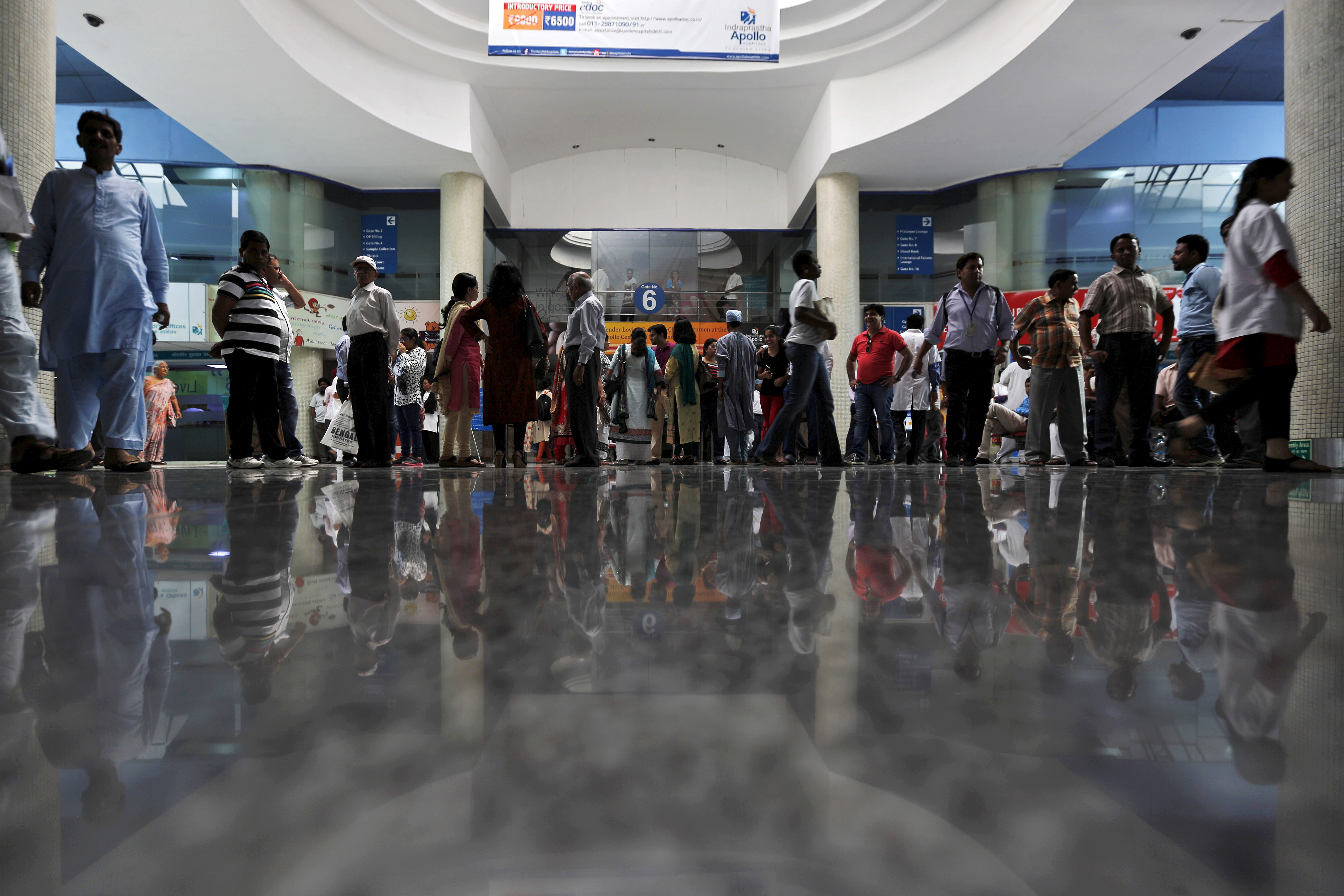 Patients and their attendants are seen inside Apollo hospital in New Delhi