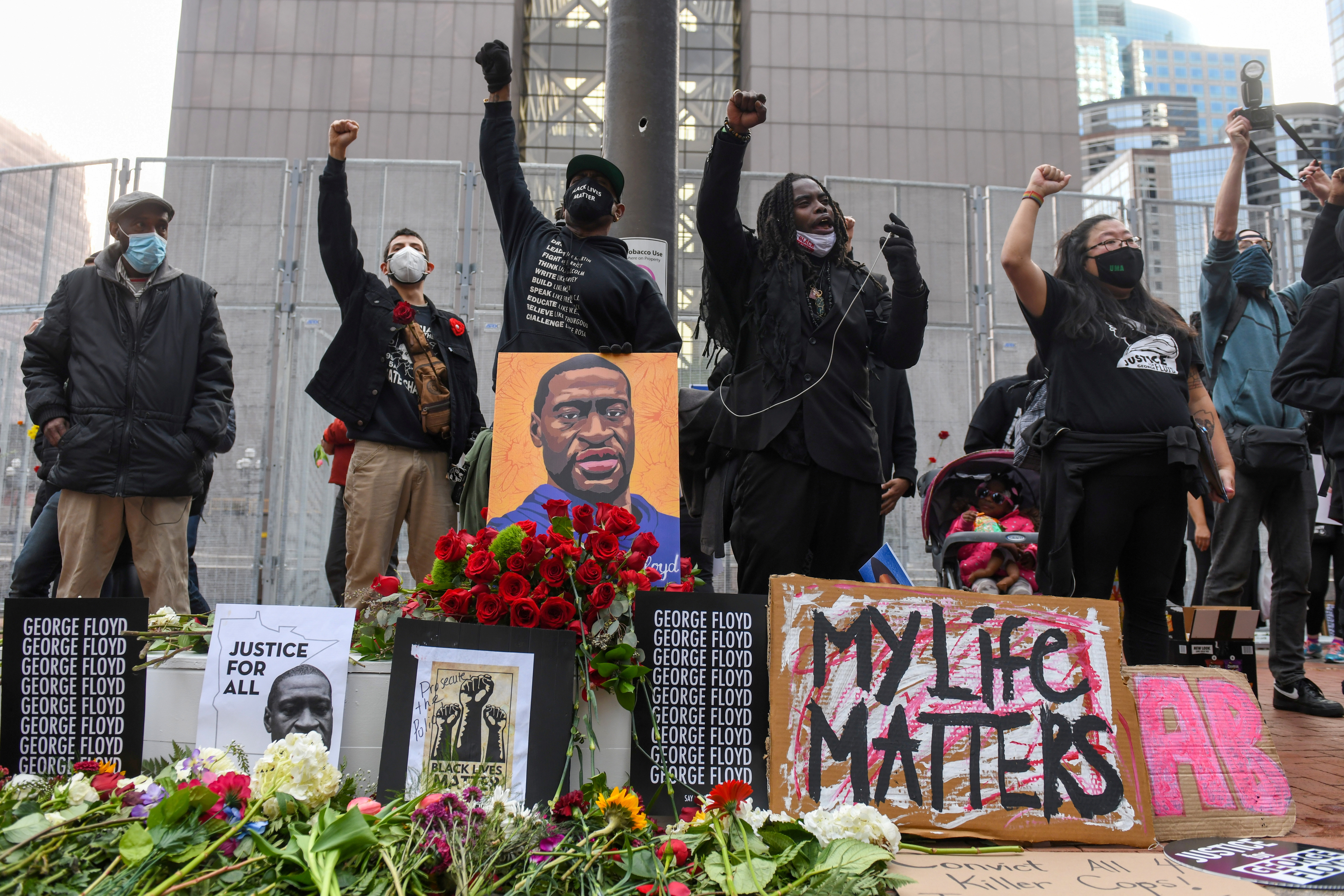 Protesters raise their fists and chant after the "I Can't Breathe" Silent March for Justice a day before jury selection is scheduled to begin for the trial of Derek Chauvin, the former Minneapolis policeman accused of killing George Floyd, in Minneapolis, Minnesota, U.S. March 7, 2021. REUTERS/Nicholas Pfosi