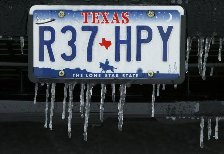 ICE HANGS FROM LICENSE PLATE AFTER WINTER STORM IN DALLAS TEXAS.