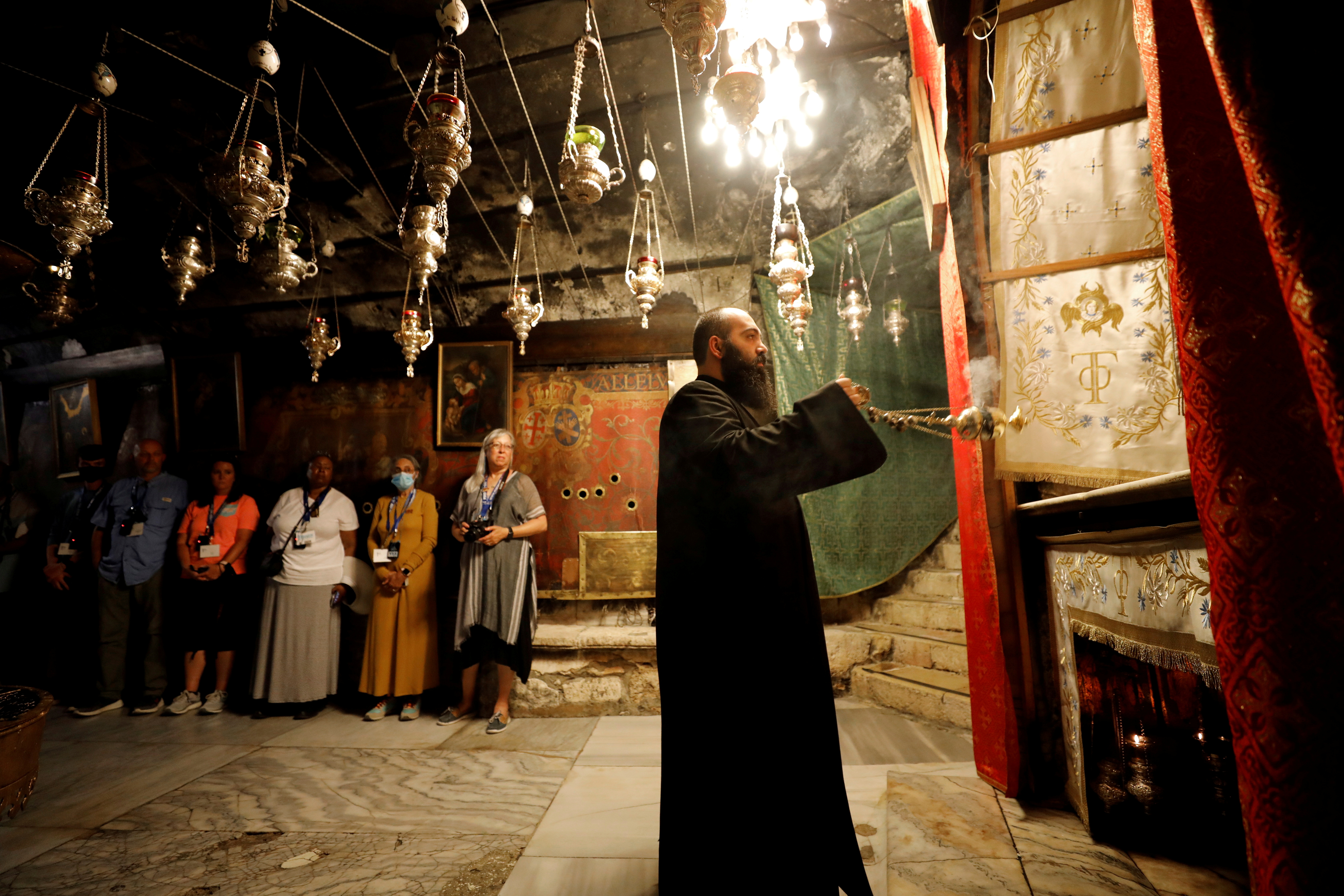 Foreign tourists visit the church of Nativity in Bethlehem, as the coronavirus disease (COVID-19) restrictions ease